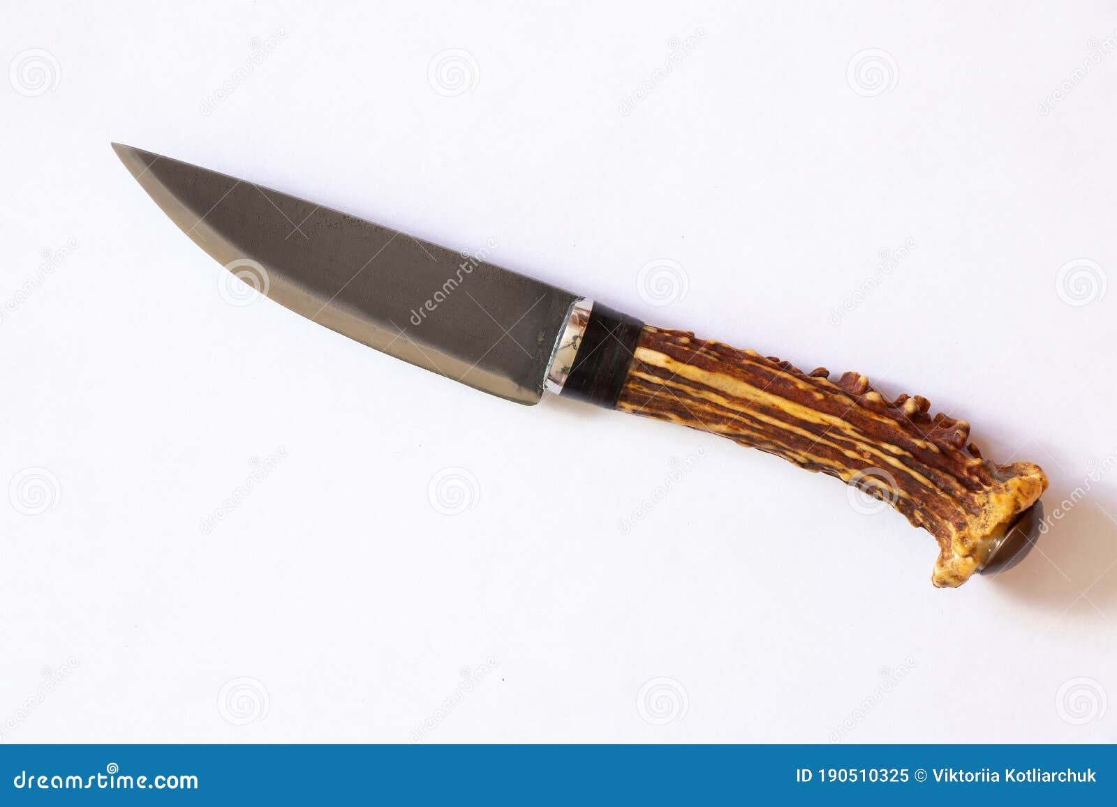 Knife with a Handle of a Deer Antler on an Isolated Color Background