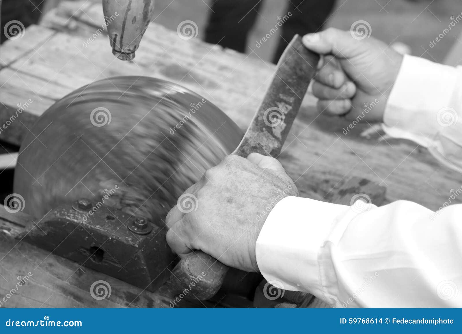 Knife Sharpener while Sharpening the Blade of the Knife on the L Stock