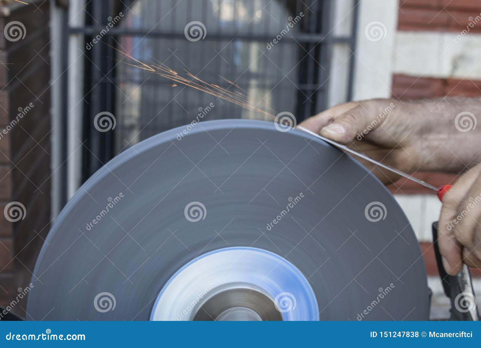 Knife Sharpening Hand and Sanding Machine Closeup Stock Photo Image
