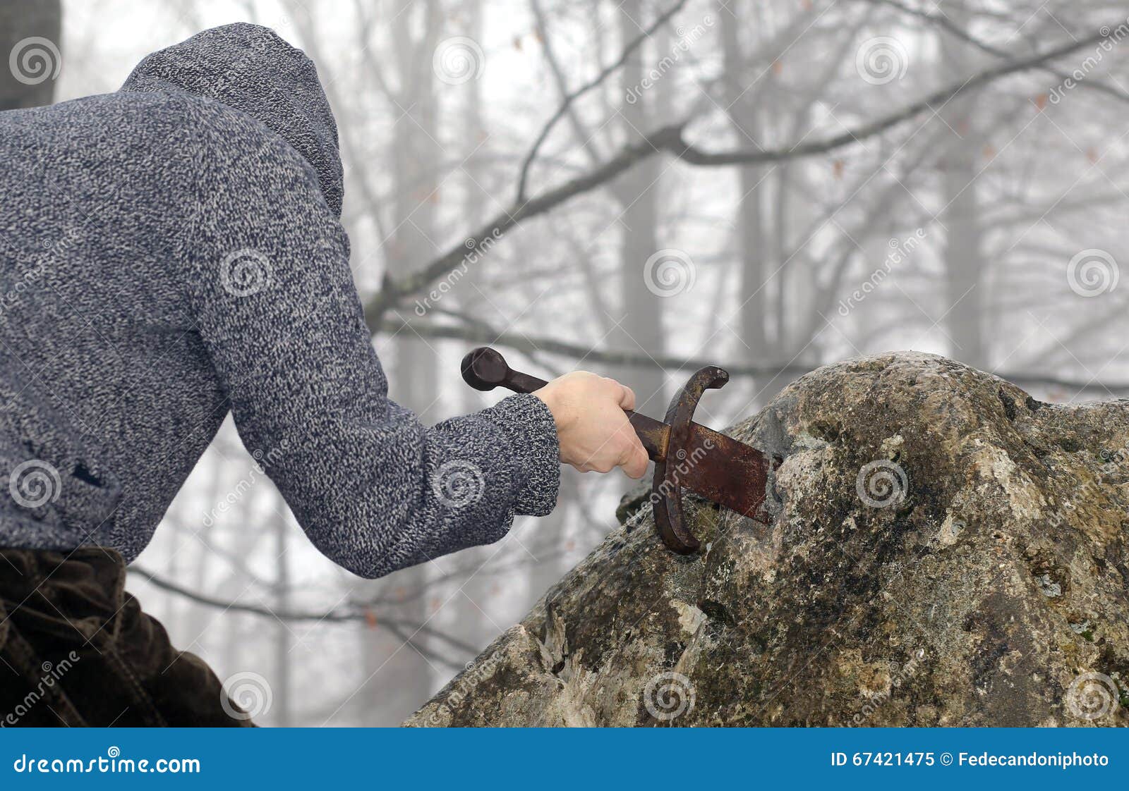 Knight Removes the Magical Excalibur Sword in the Stone Stock Image