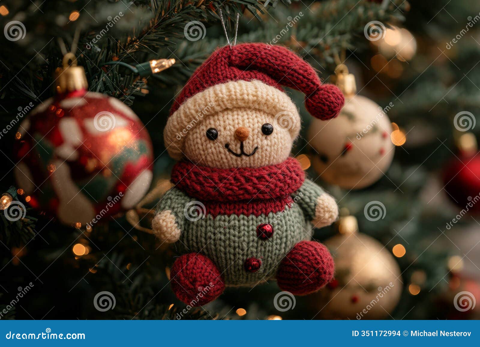 knitted snowman ornament hanging on a christmas tree, adding a touch of handmade charm to the festive decorations