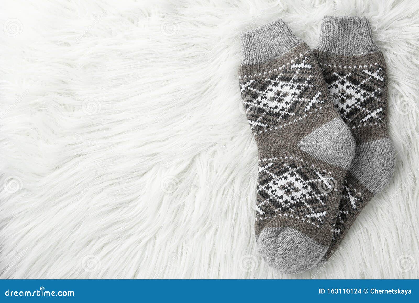 Knitted Socks on White Faux Fur. Space for Text Stock Photo - Image of ...