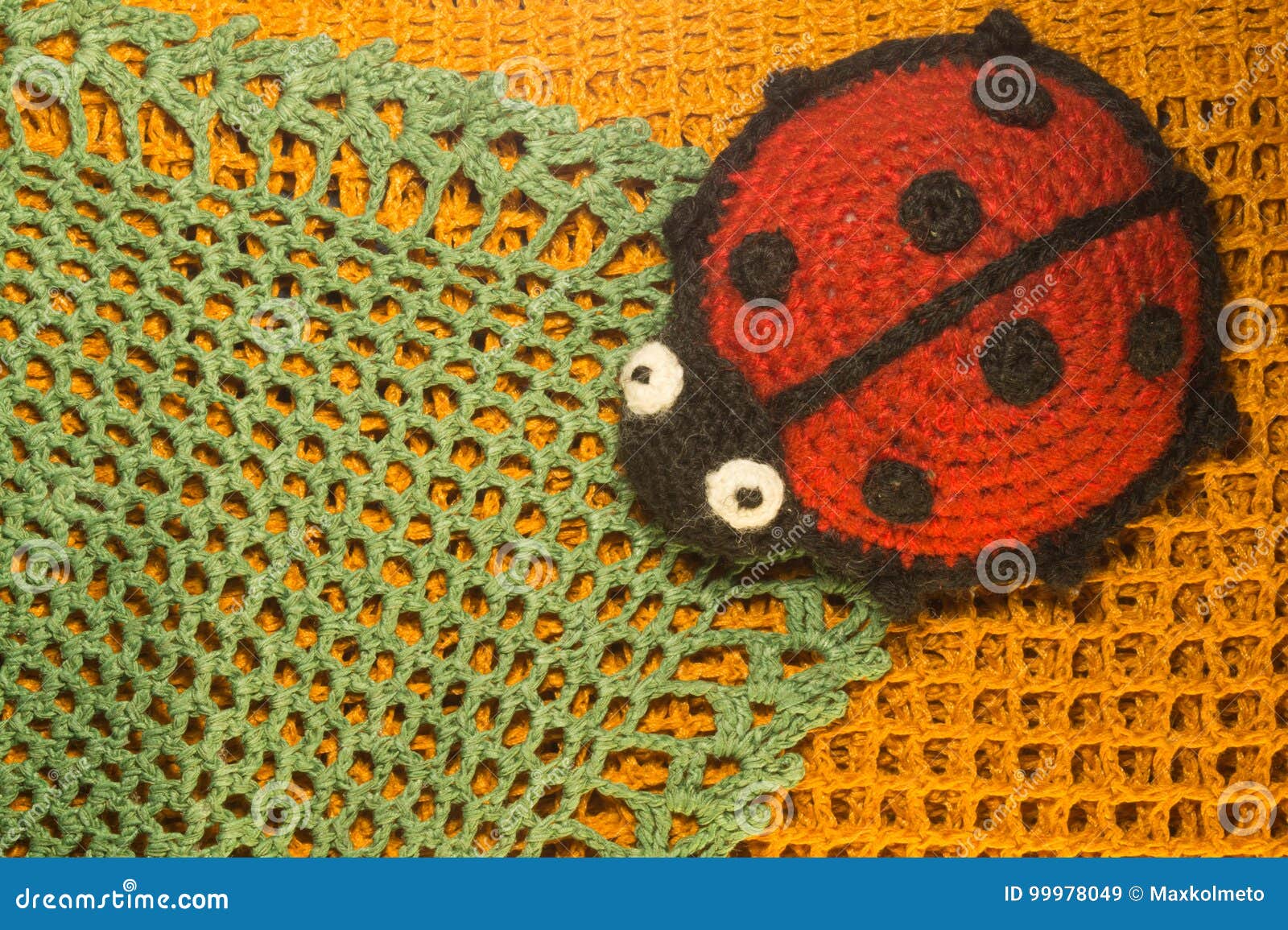 knitting wool toy ladybug on the blamket colorful texture background