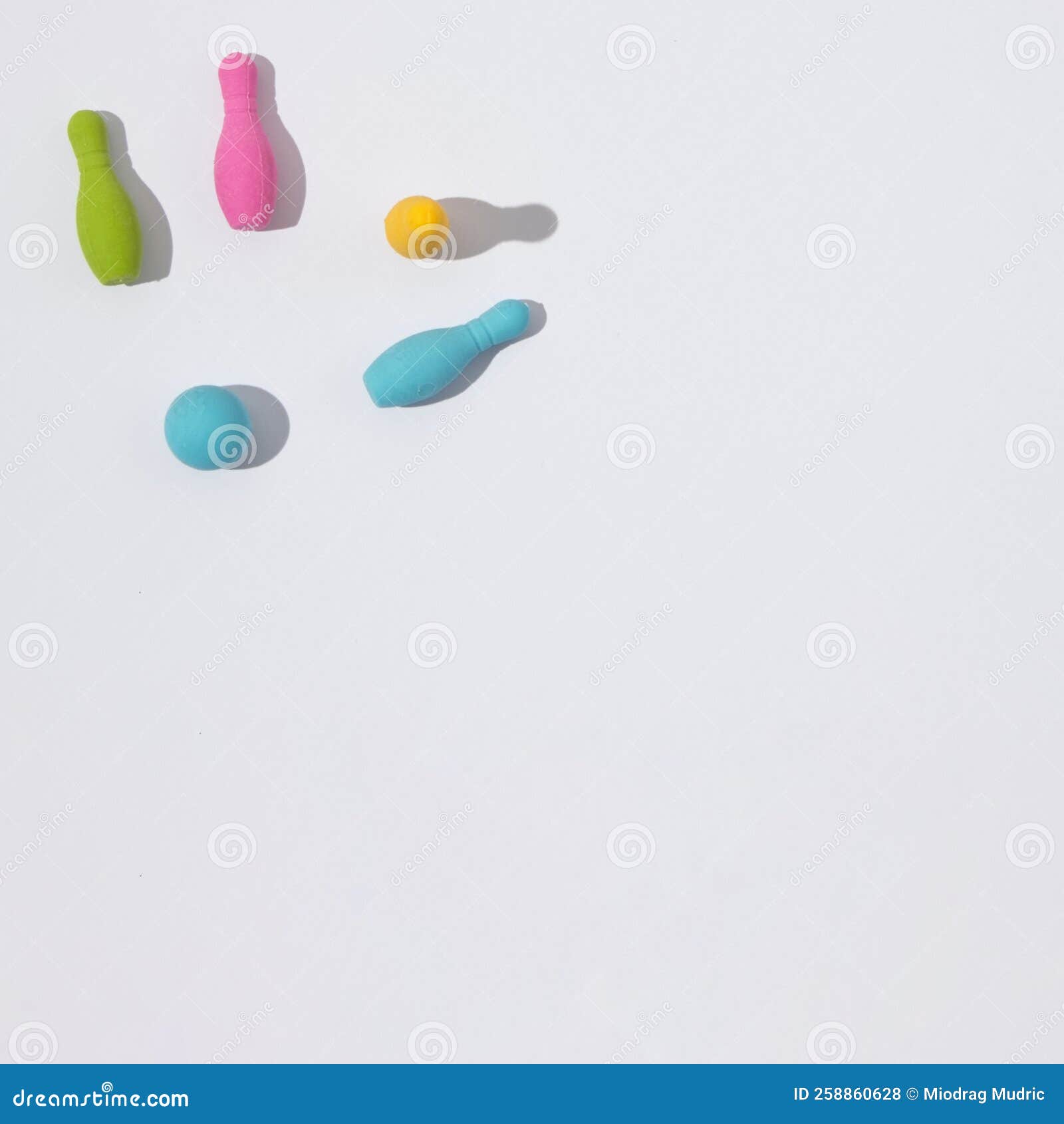 Knocked Down Bowling Pins on a White Background with Copy Space