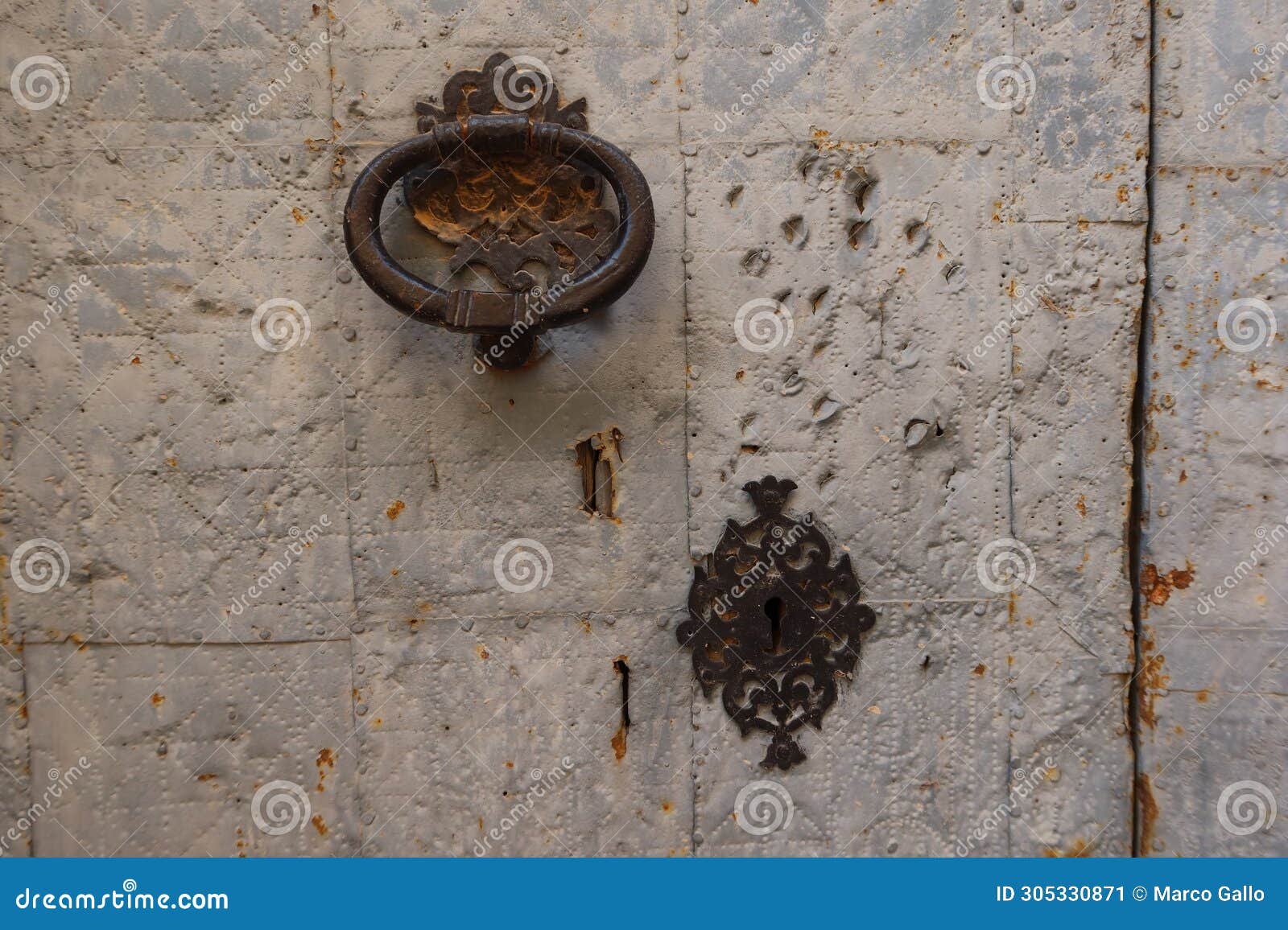 knocker and lock of one of the doors of the san lorenzo martir church, 16th century. busot, alicante, spain