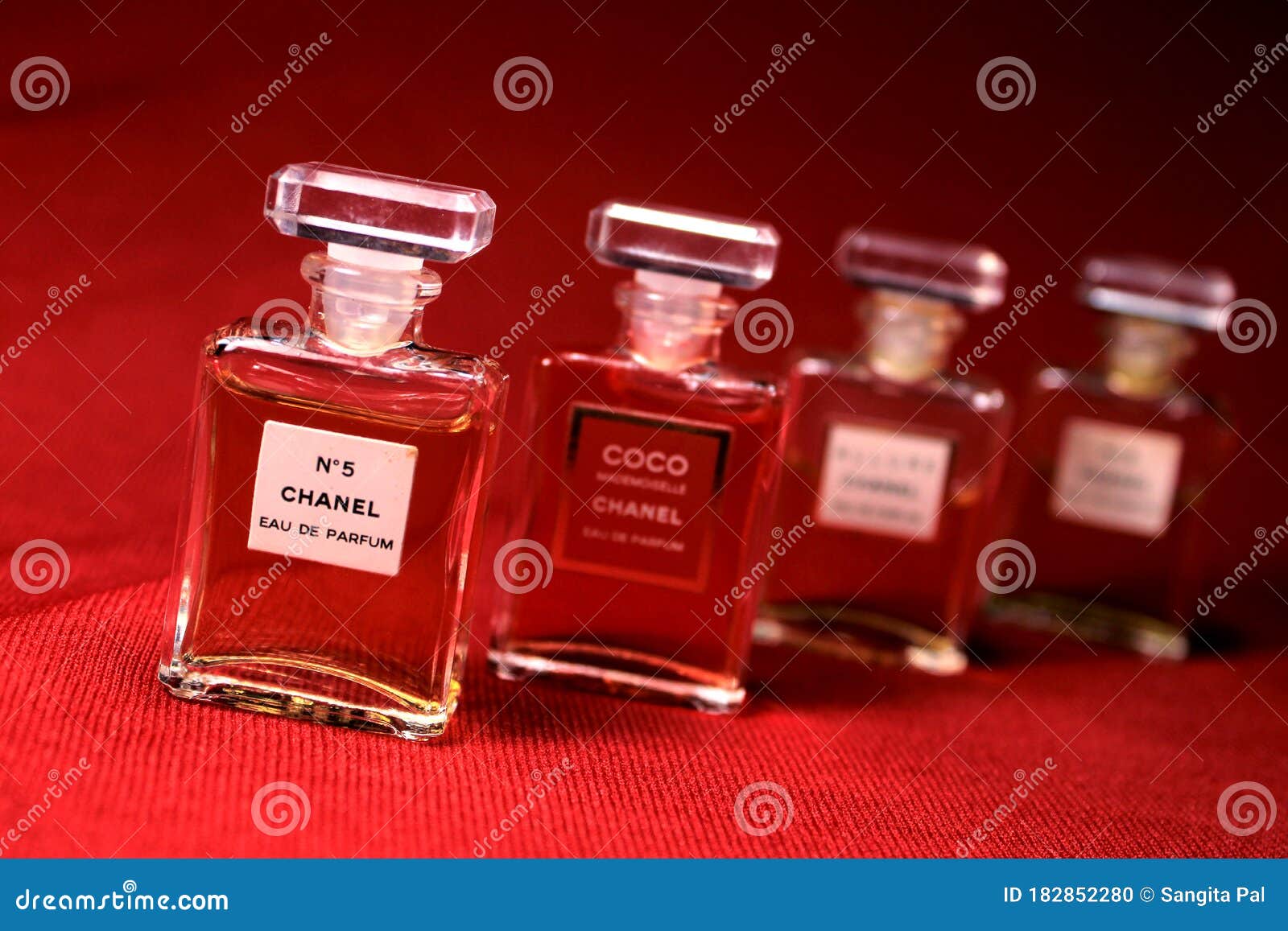 Chanel Perfume Bottles Isolated on Red Background. Bottles with ...