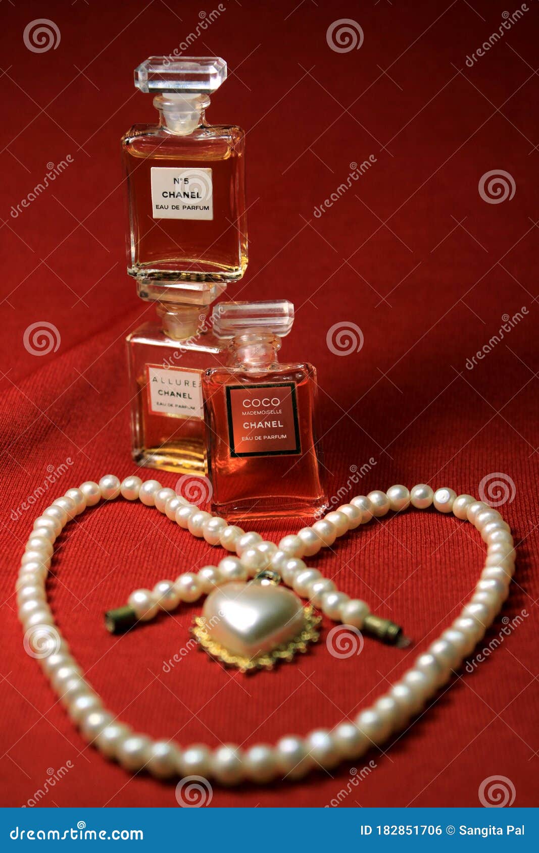 Chanel Perfume Bottles Isolated on Red Background. Bottles with Different Chanel  Perfume Products with Female Accessories. Editorial Photo - Image of aroma,  body: 182851706