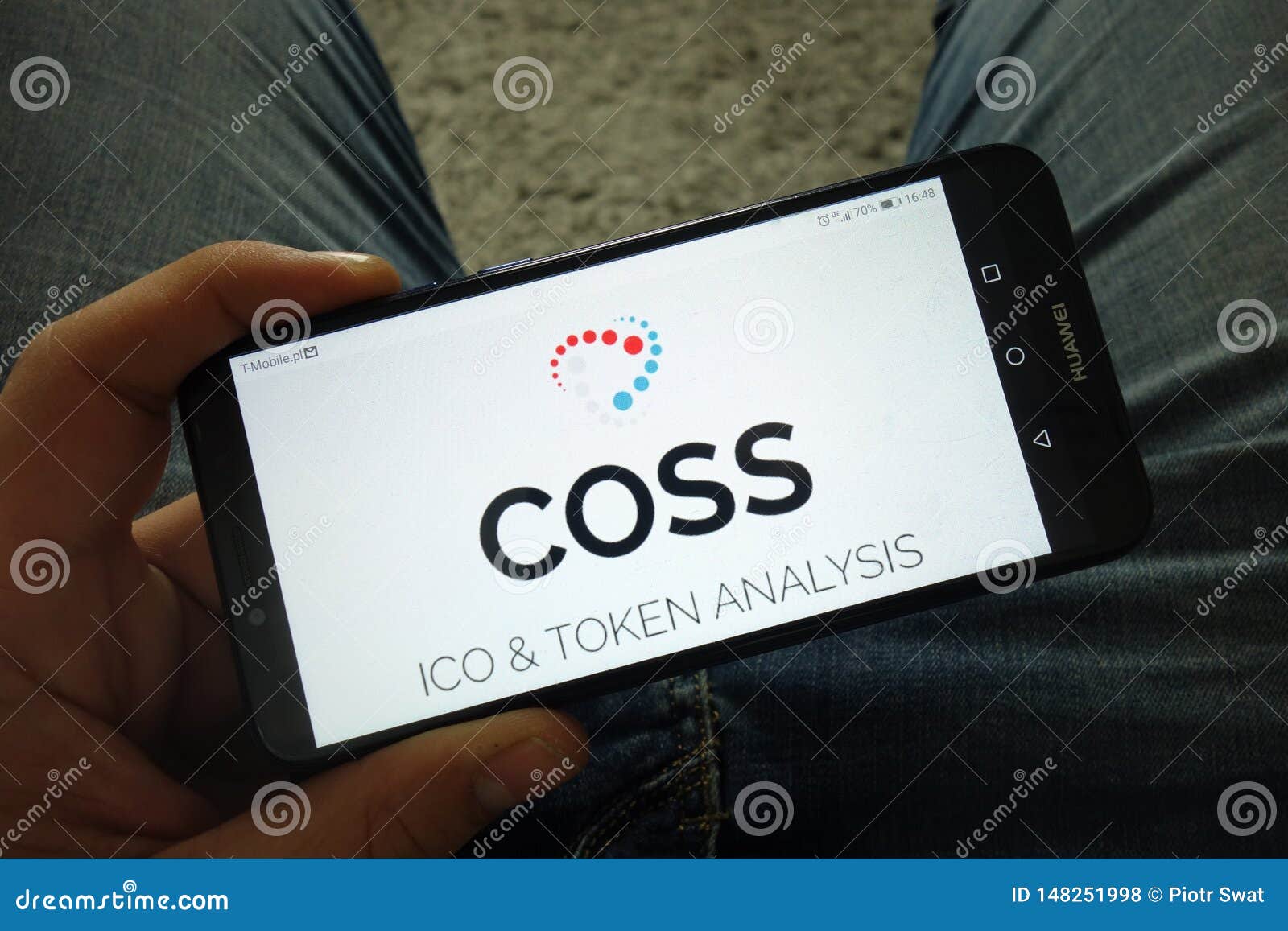 Man Holding Smartphone With COSS Cryptocurrency Exchange ...