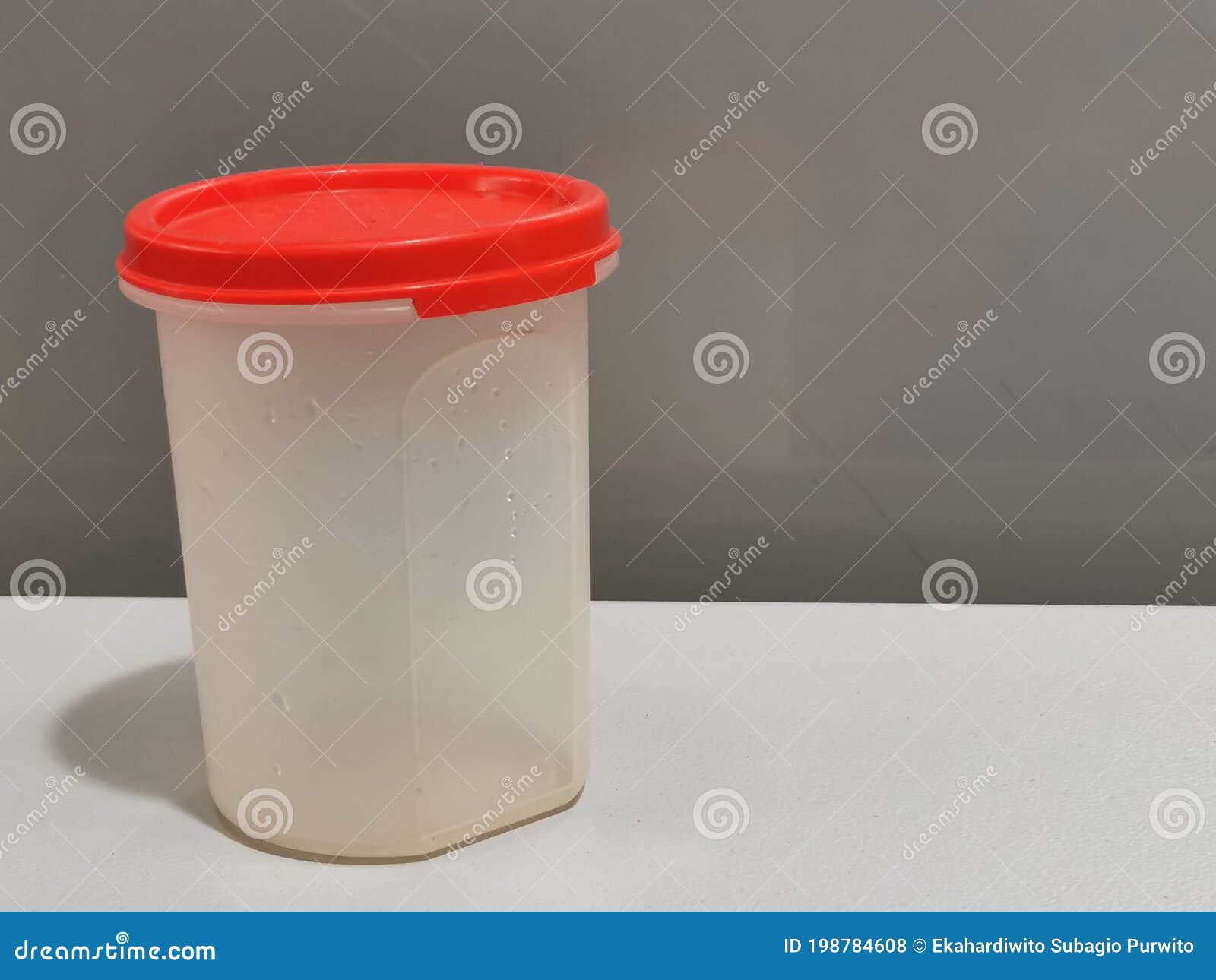 image of storage container by tupperware brand  on grey background.