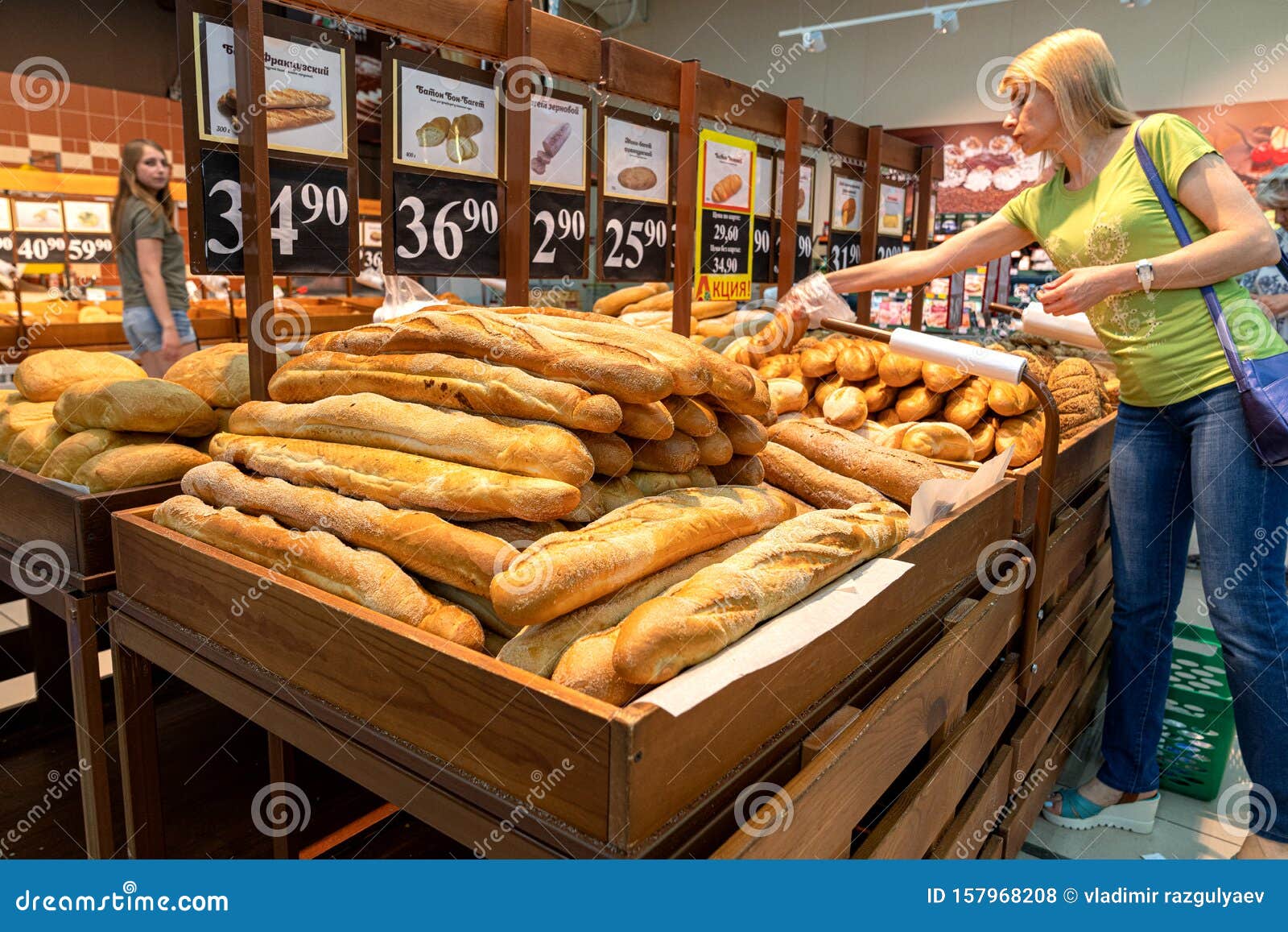 Krasnoyarsk, Russia, 27 Augus 2019: a Woman Buys Baguettes in a Bakery