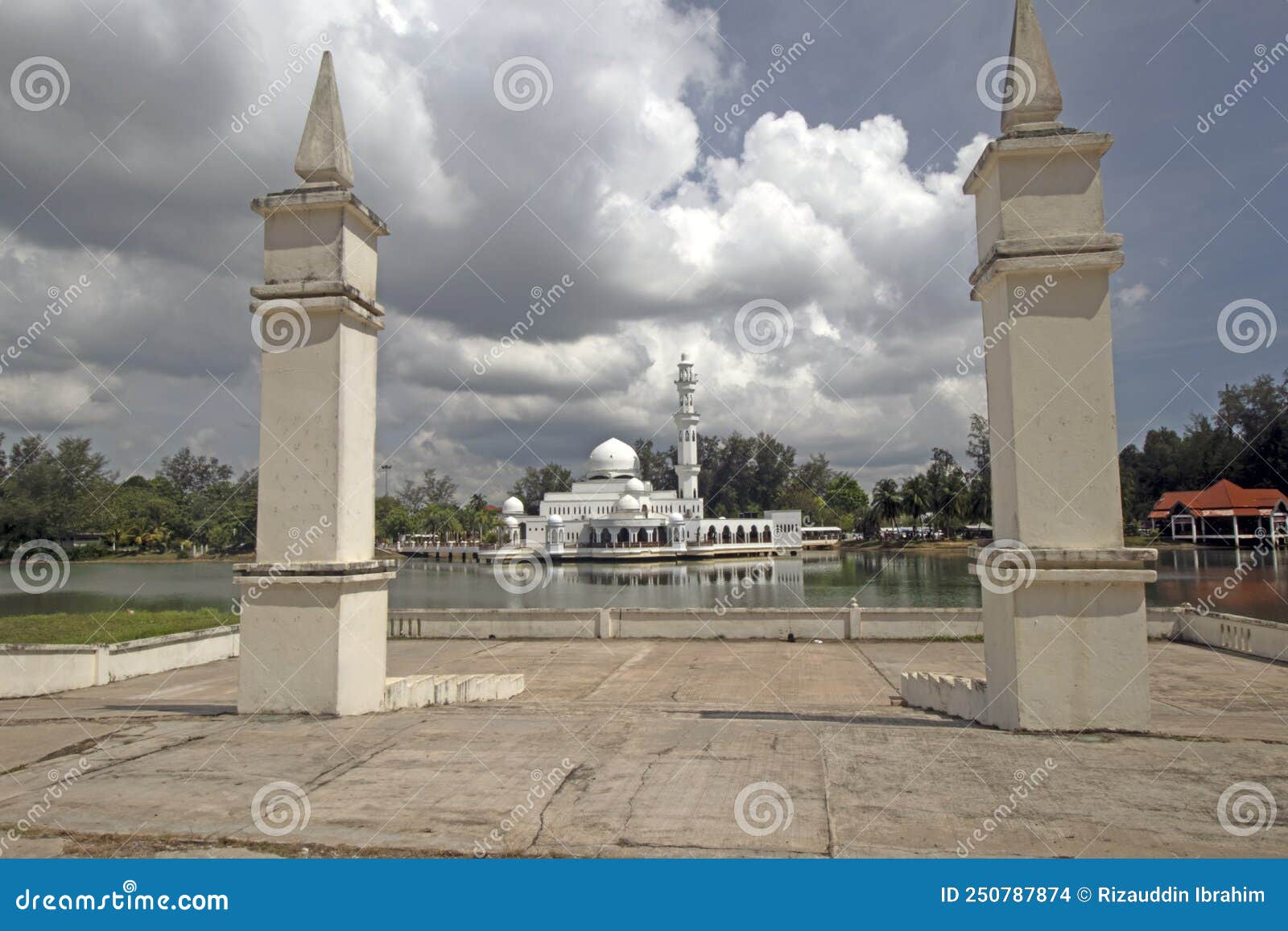 the kuala ibai floating mosque or tengku tengah zaharah mosque under heavy clouds as seen from lakeside pavilion in terengganu, m