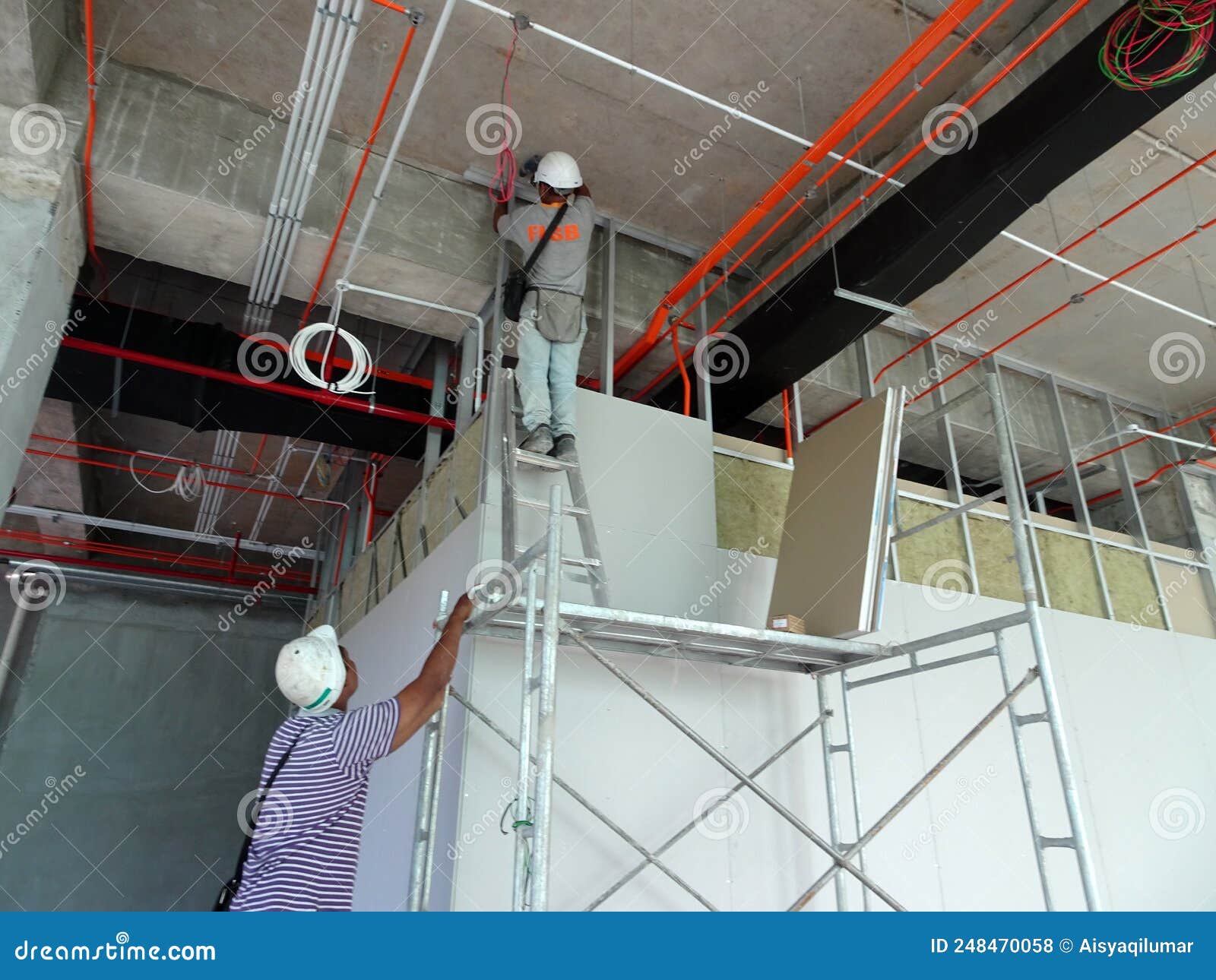 Drywall Installation Work in Progress by Construction Workers at the