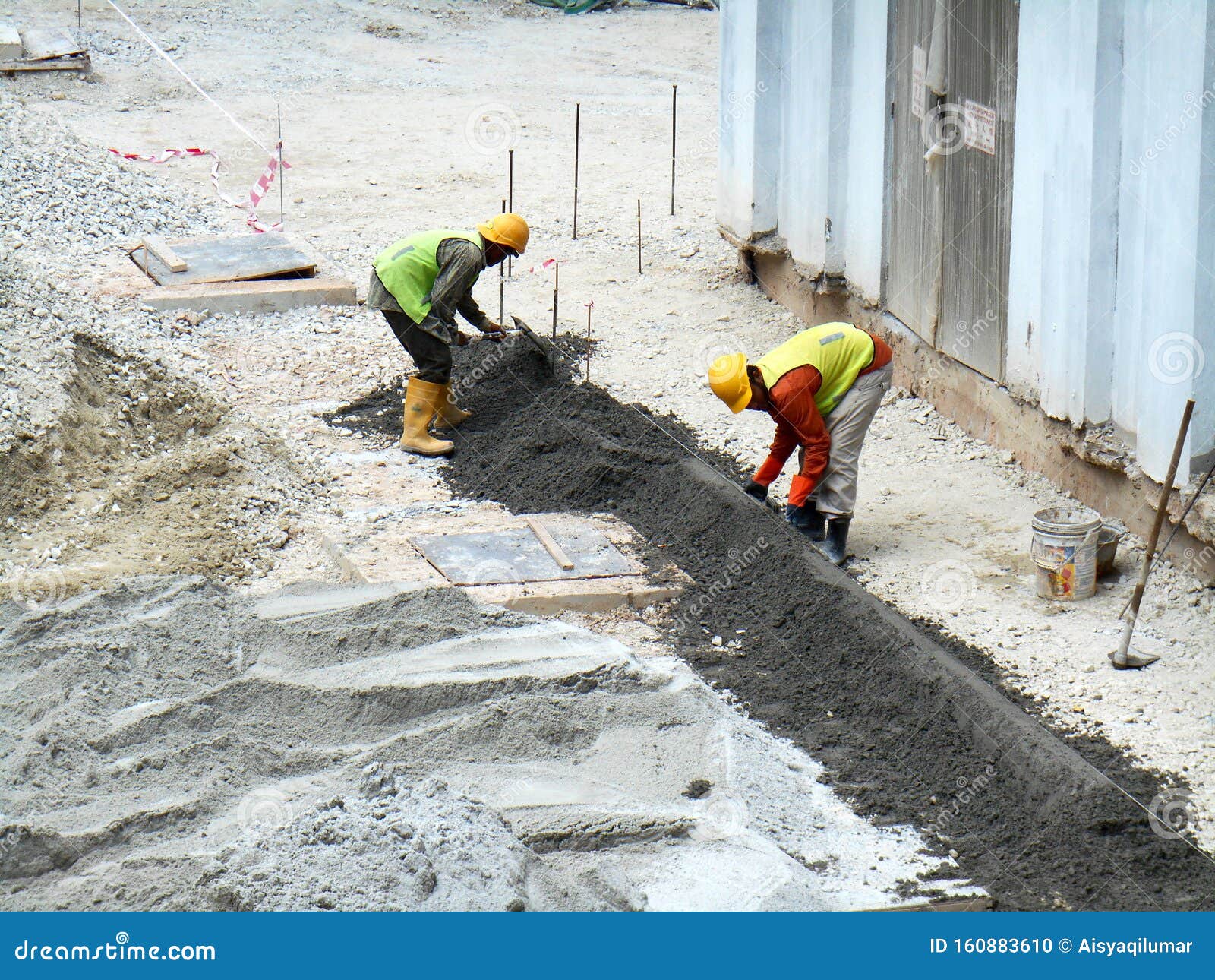 Construction Workers Creating Concrete Road Curb at the Construction ...