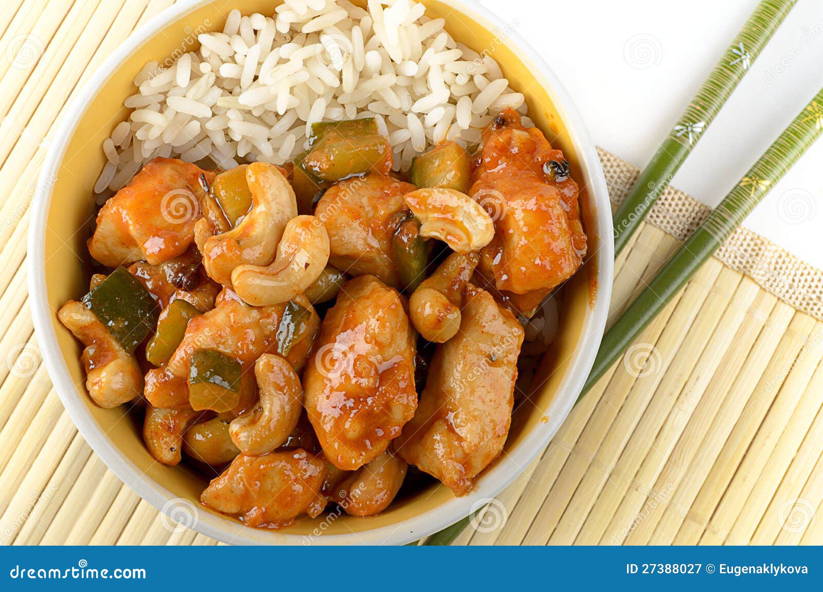 kung pao chicken with rice and chopsticks