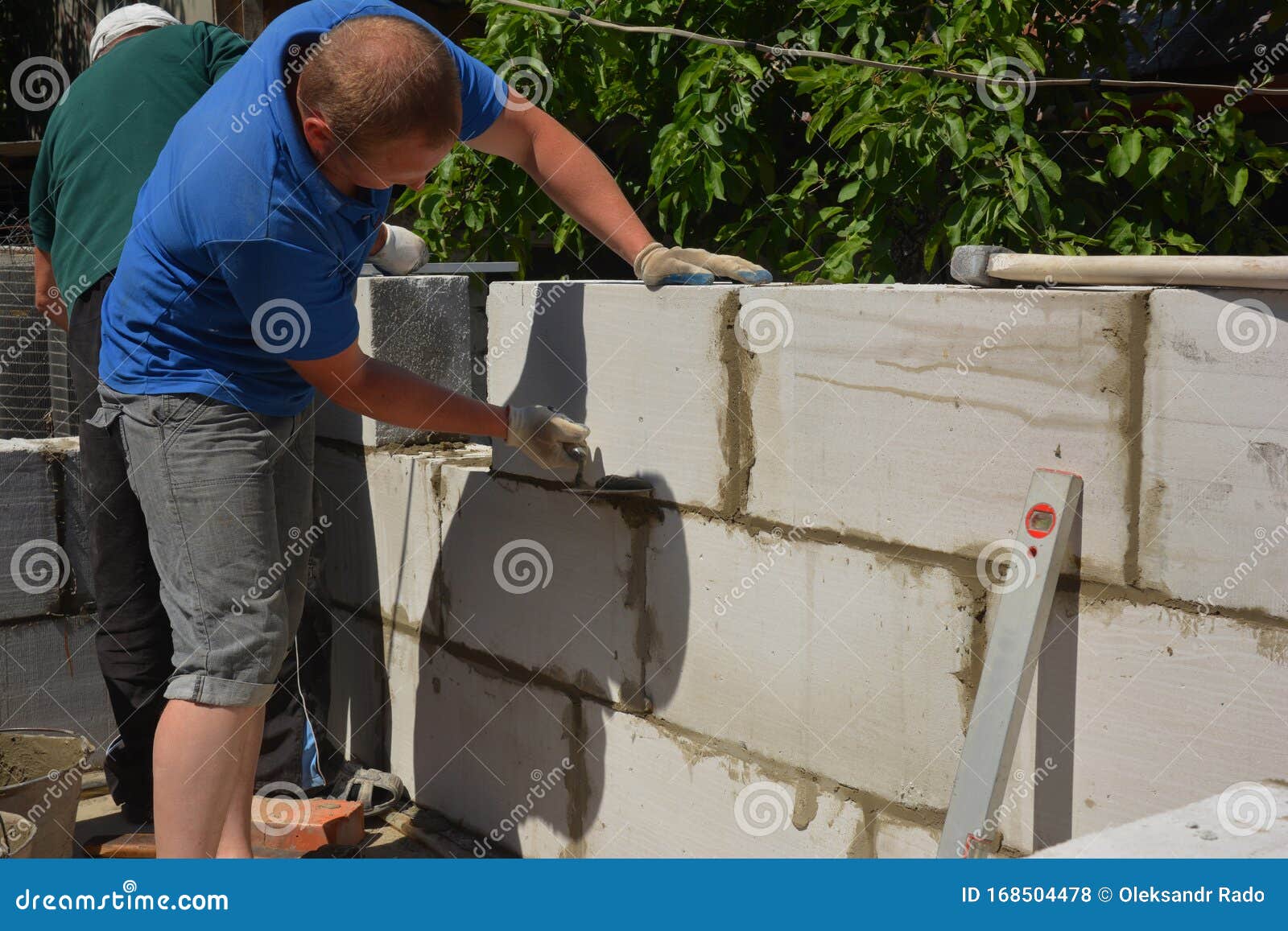 Bricklayer Builder Laying Autoclaved Aerated Concrete Blocks for House