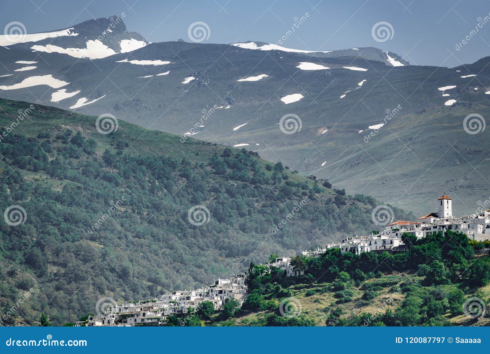 white andalusian village of capileira with veleta mountain peak
