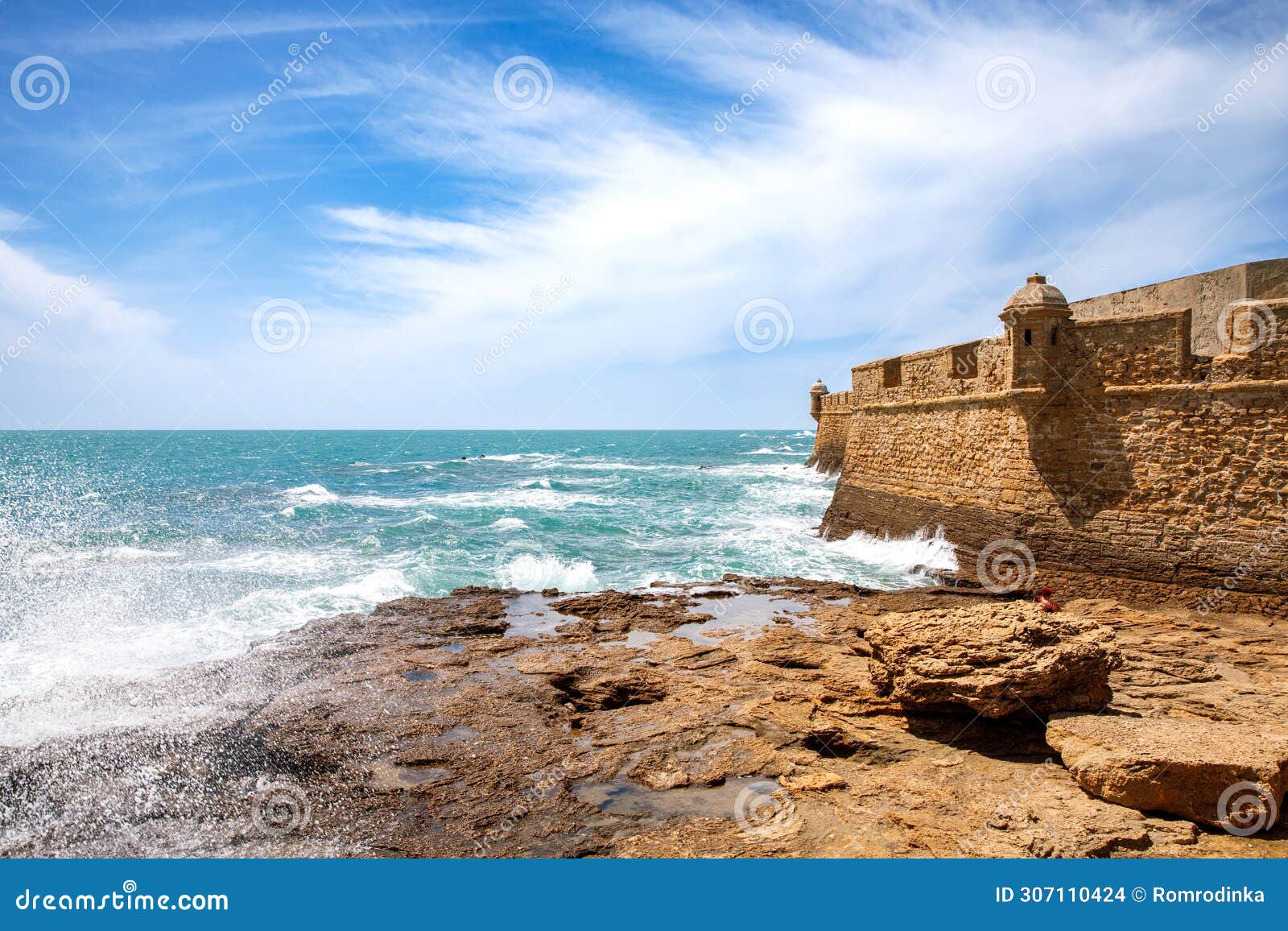 la caleta beach, balneario de la palma building and castle of san sebastian at sunset - cadiz, andalusia, spain