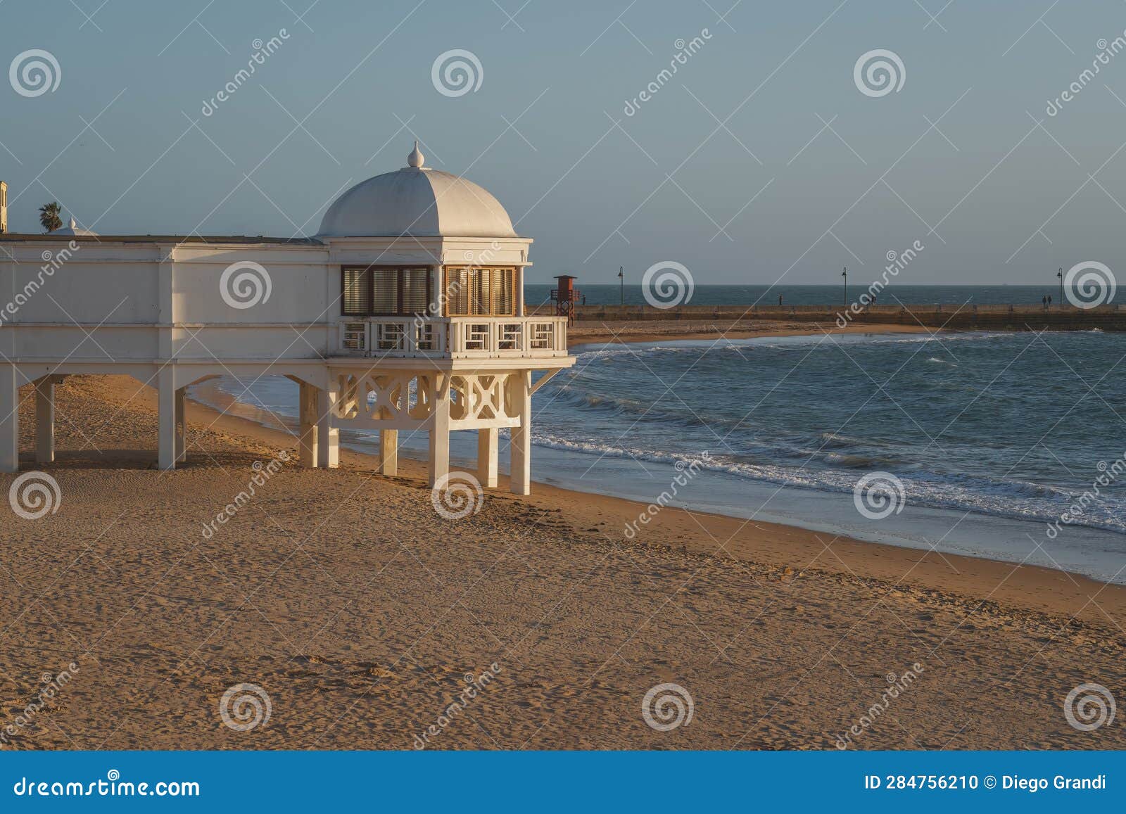 la caleta beach and balneario de la palma building at sunset - cadiz, andalusia, spain