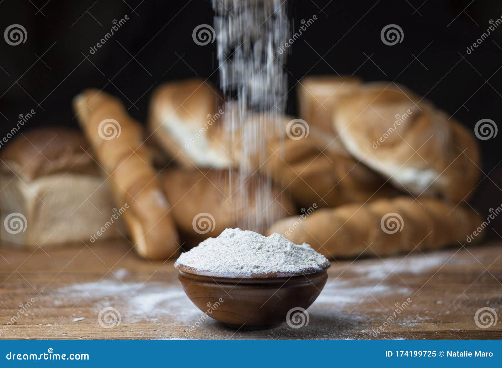 Cuillère de farine versée dans un bol foto de Stock