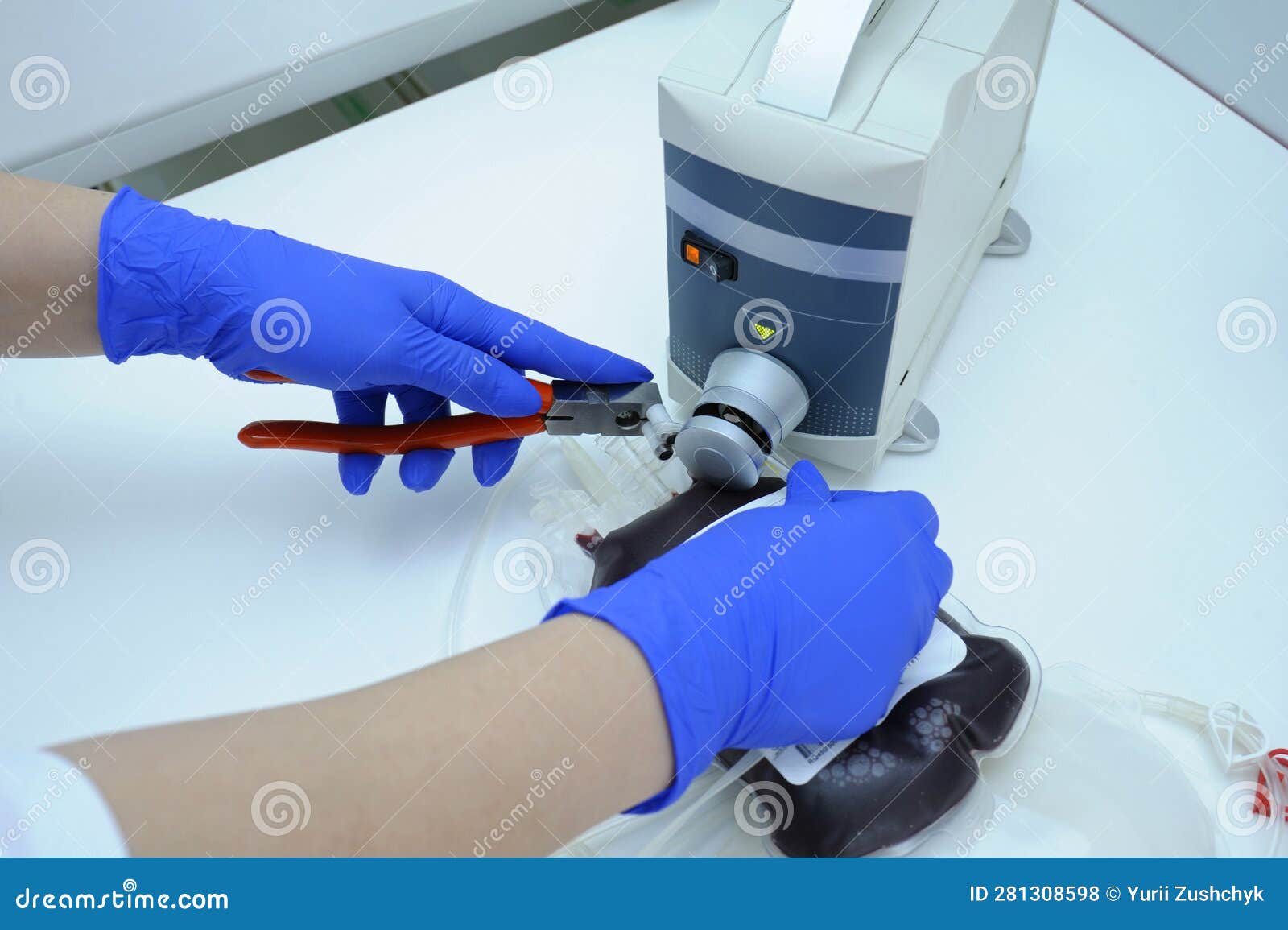 Lab Assistant Hands Sealing Container with Blood Using Automatic Blood