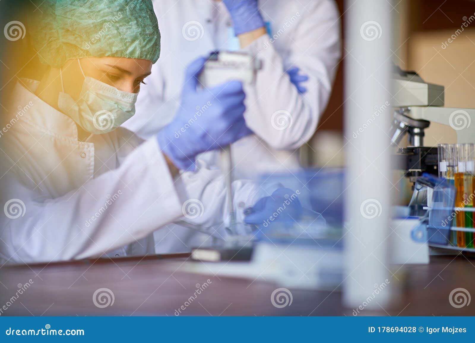 Lab Technician Examining Blood Sample on Corona Virus Stock Photo