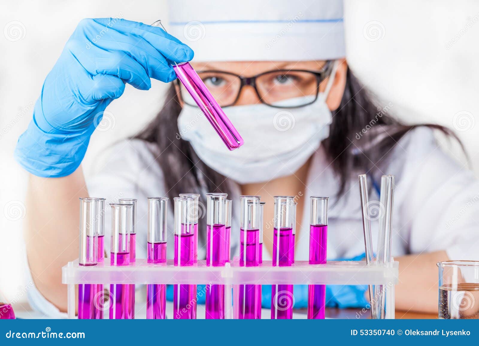 laboratorian inspects the contents of the test tubes closeup
