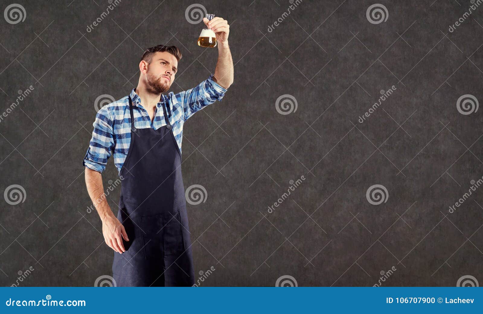 The Laboratory Assistant Brewer Winemaker Checks the Liquid in T Stock