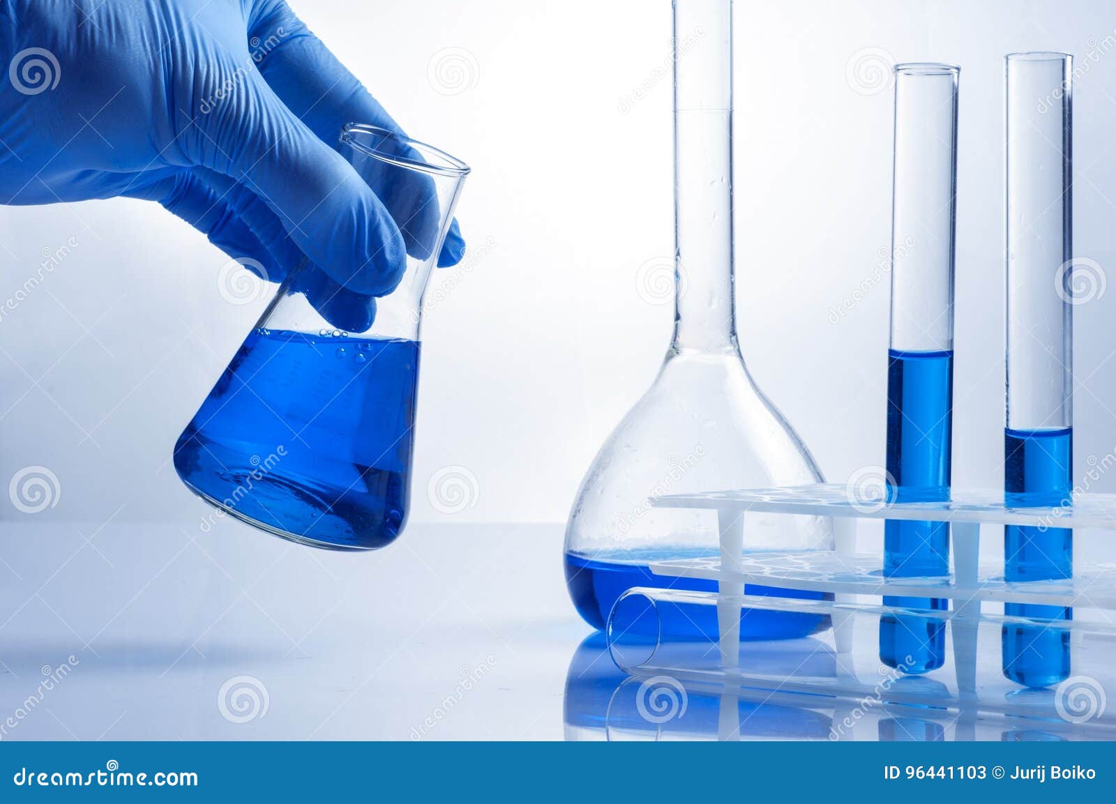 Laboratory Beaker in Analyst& X27;s Hand in Plastic Glove. Stock Image
