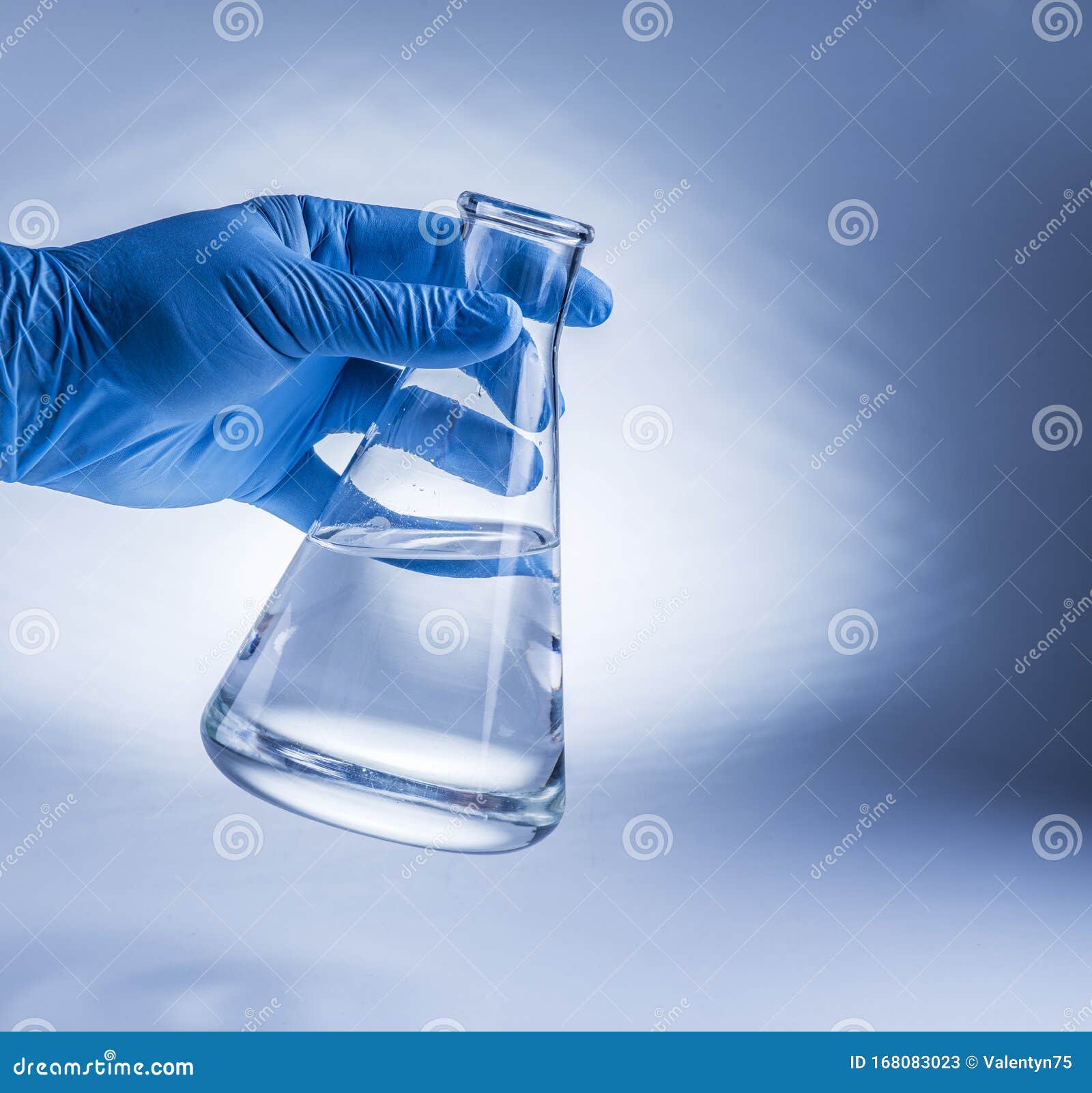 Laboratory Beaker in Analyst`s Hand in Plastic Glove Stock Image
