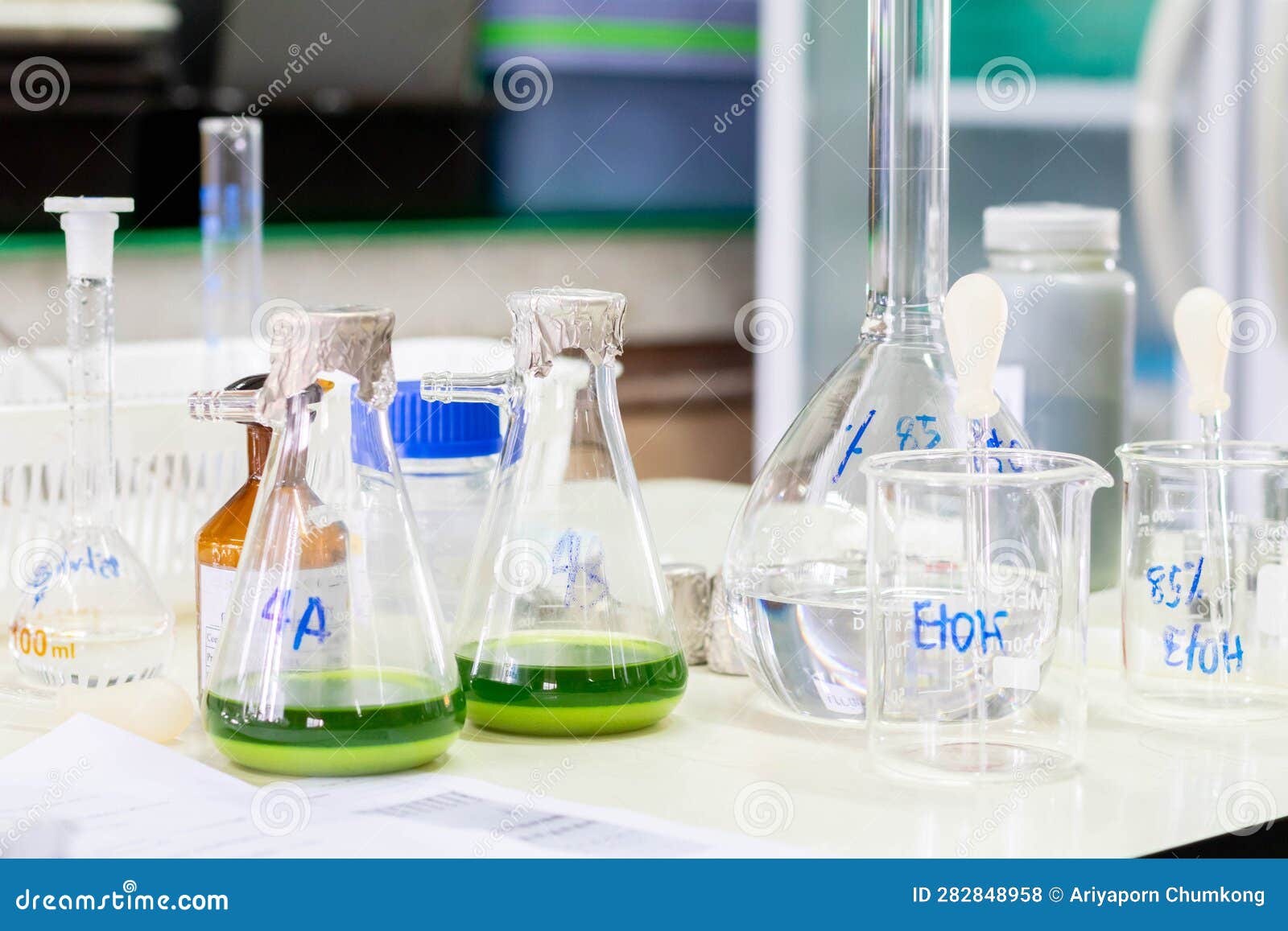Laboratory Glassware with Green Liquid in a Science Research Laboratory