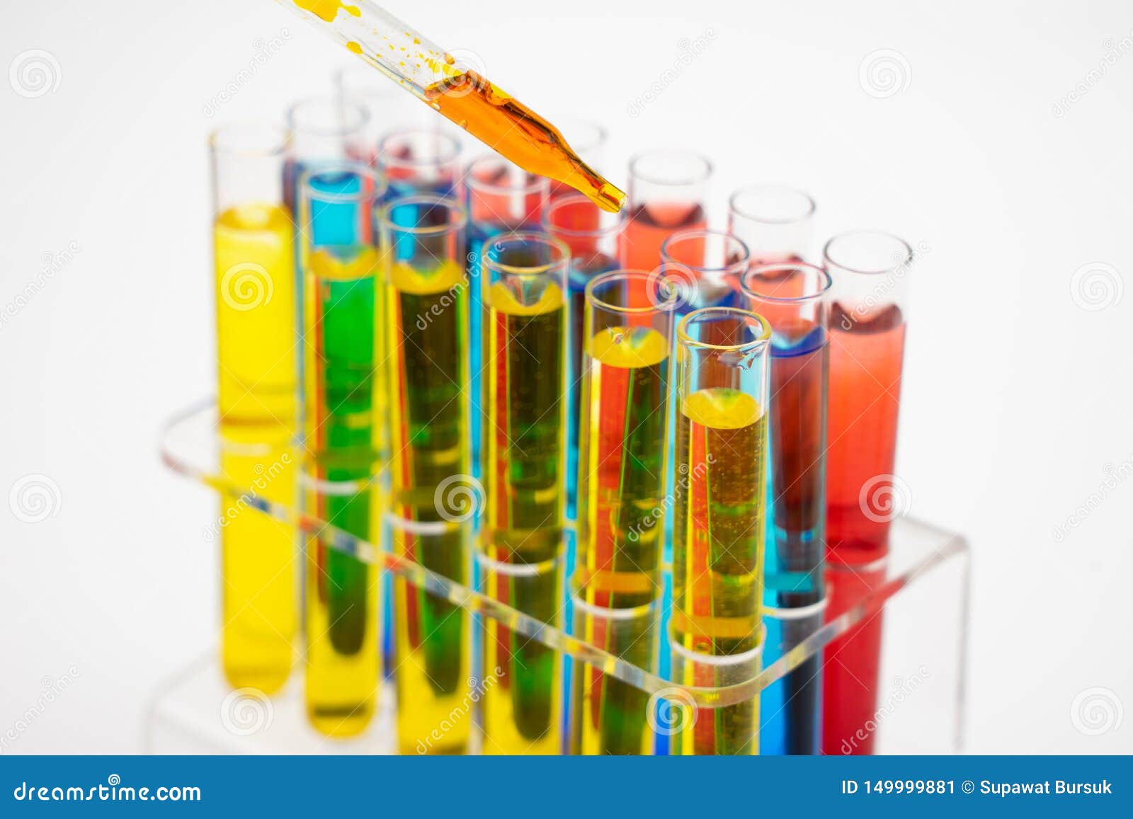 in the laboratory, scientists synthesized and analyzed the compound by dropping colored liquid in test tubes. white background
