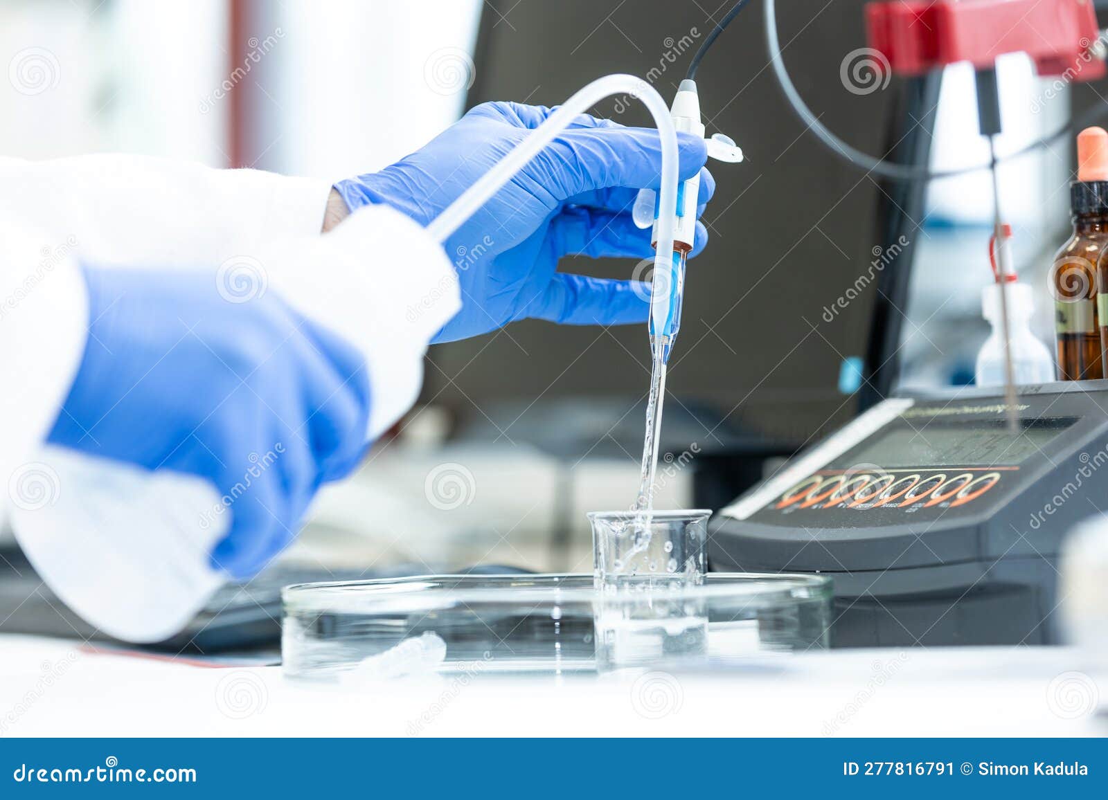Laboratory Technician Holding Glass Electrode for Measuring of PH of