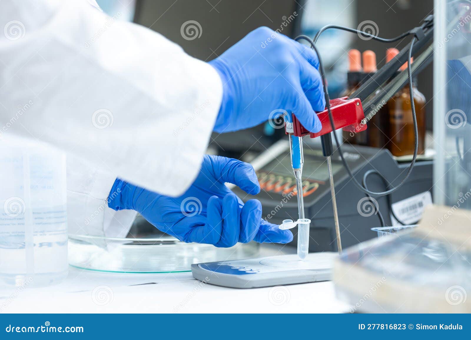 Laboratory Technician Holding Glass Electrode for Measuring of PH of
