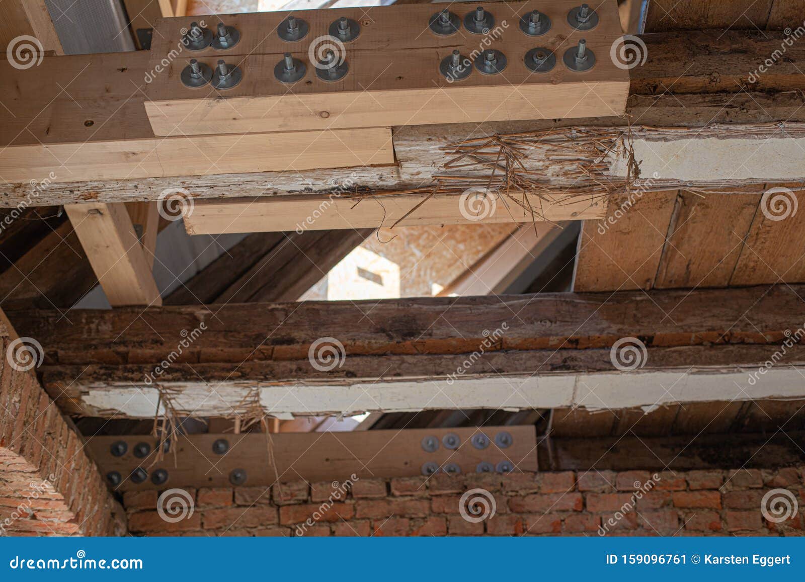 laborious work an old house is restored, whereby old beams are strengthened with new ones