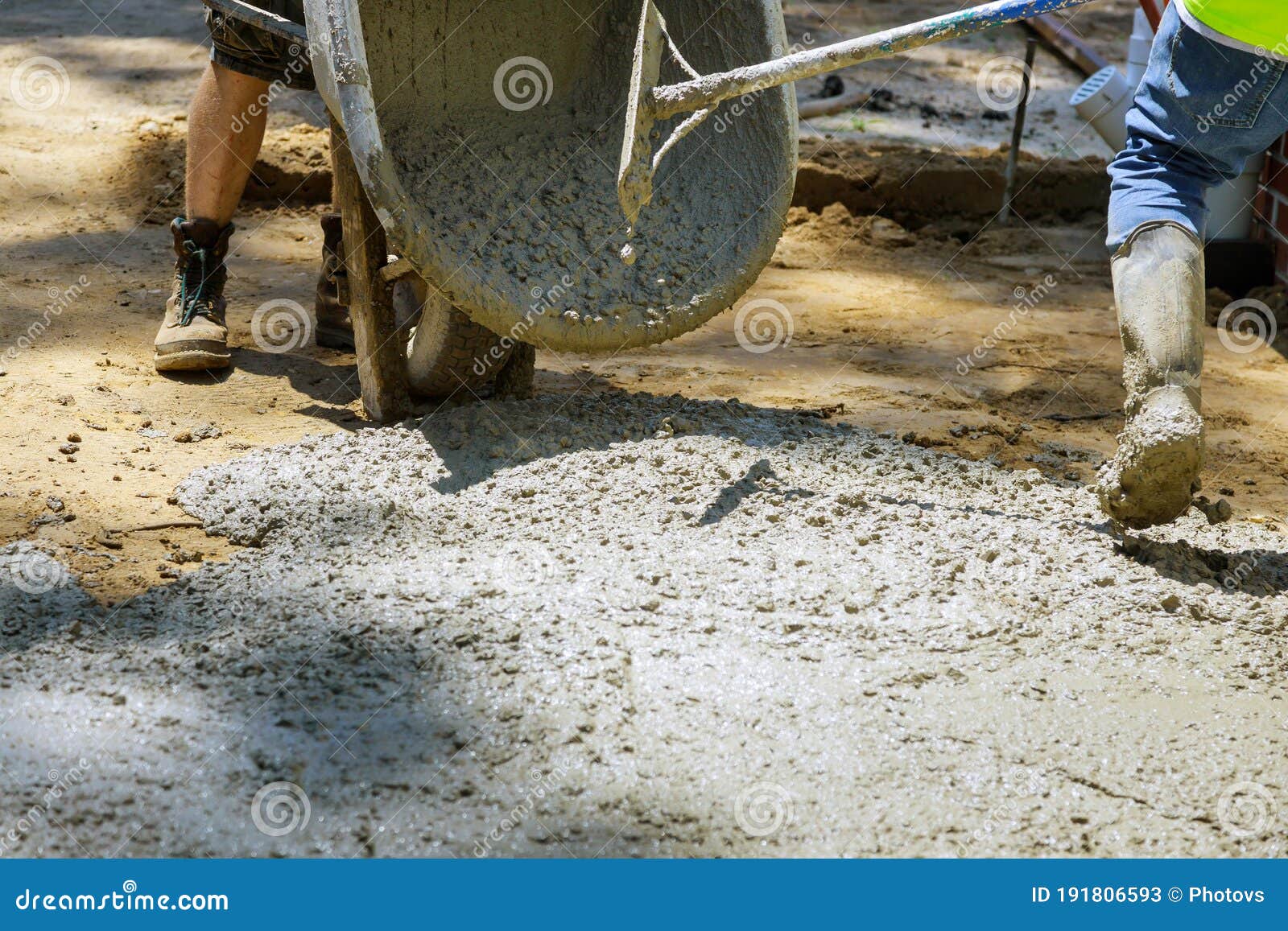 Labour Builders at Construction Site Filling Formwork with Cement