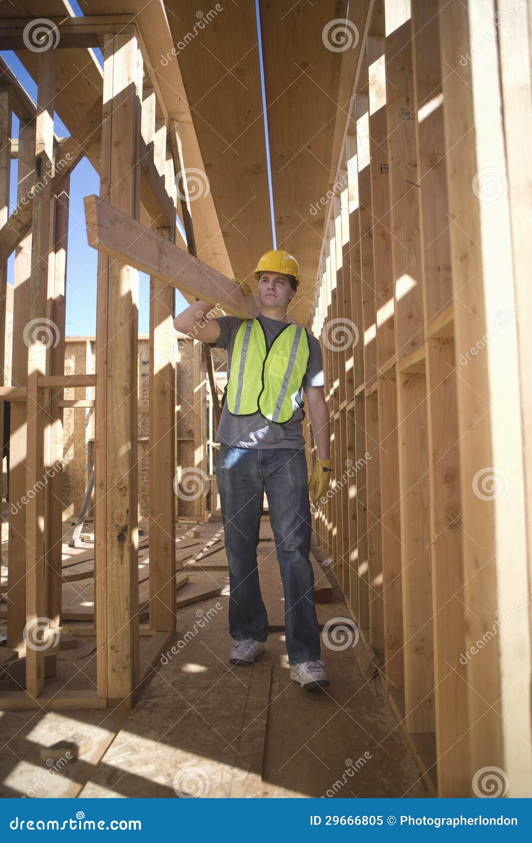 labourer carrying plank of wood