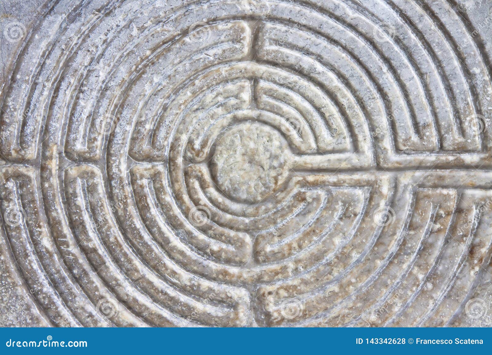 labyrinth carved on the stone facade of a romanesque church of the 11th century tuscany - italy
