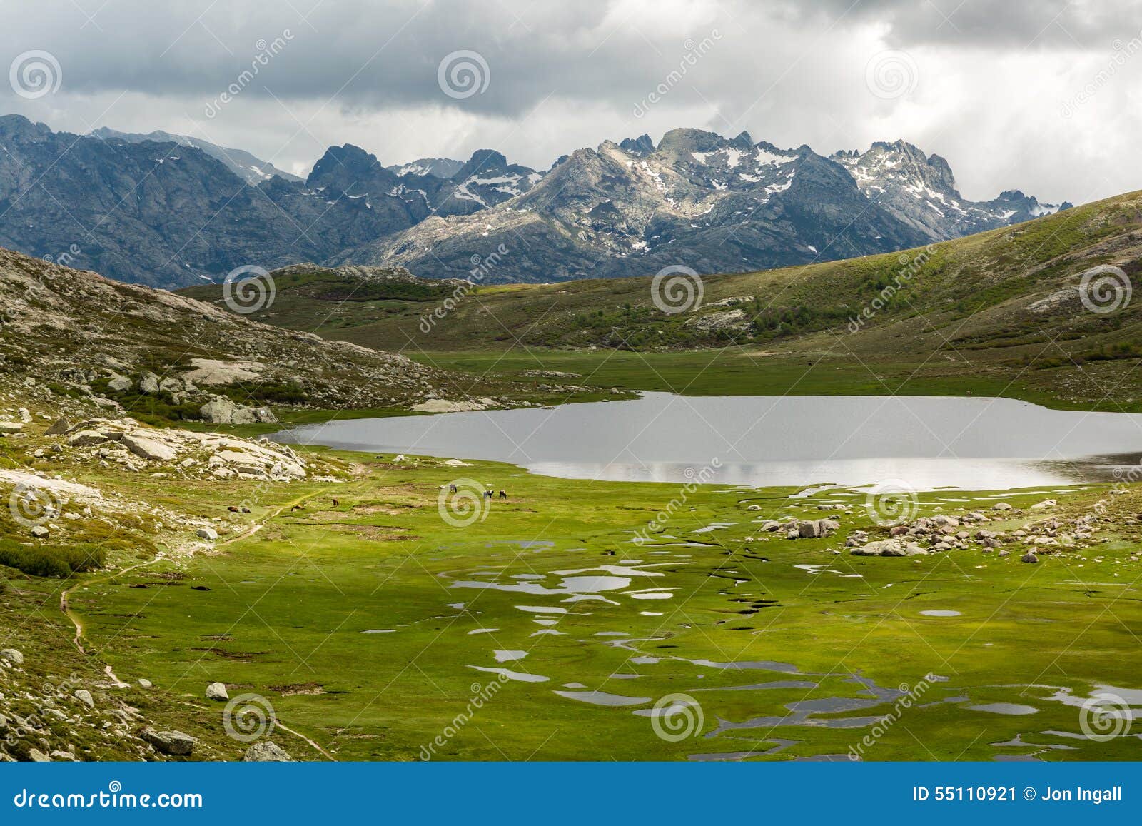 lac de nino in corsica with mountains in the background