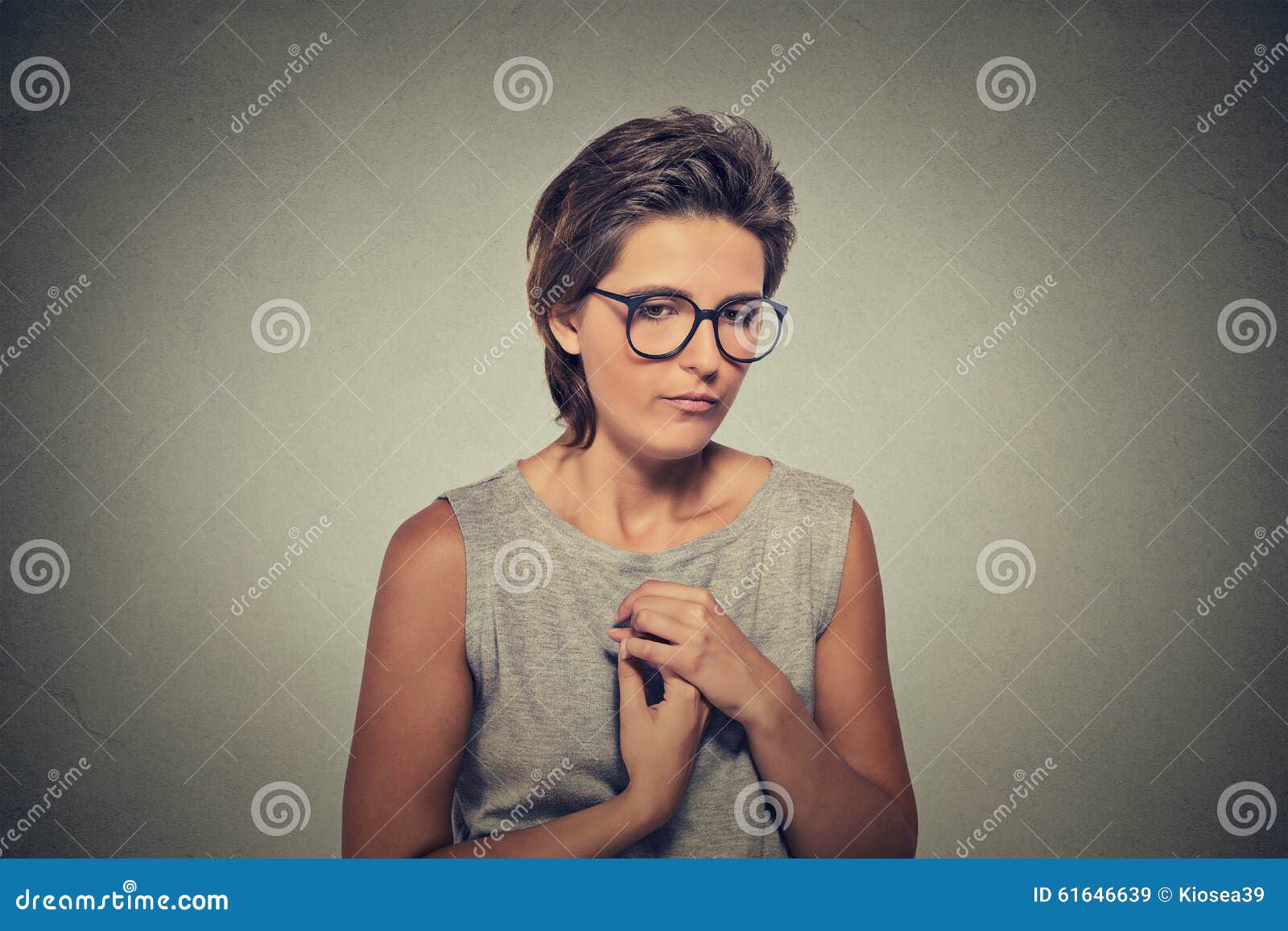 lack of confidence. shy young woman in glasses feels awkward