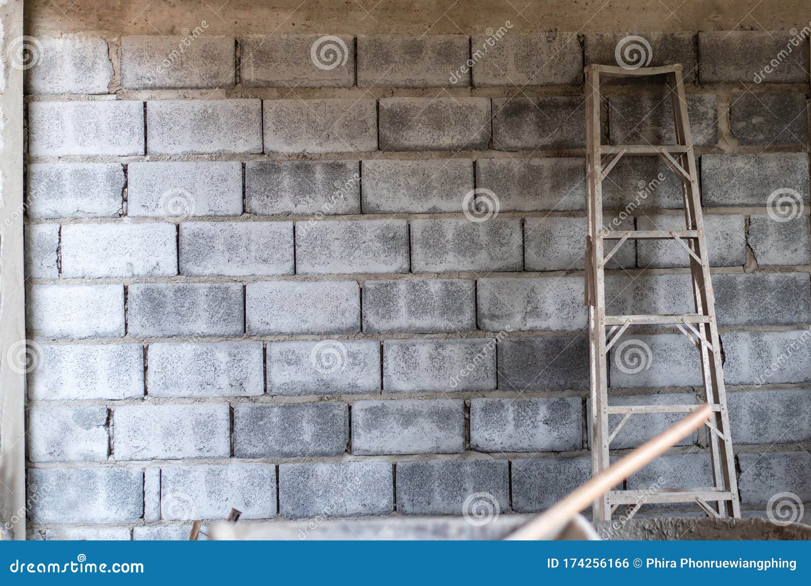 Ladder for Construction on Concrete Wall. Construction Site Stock Photo