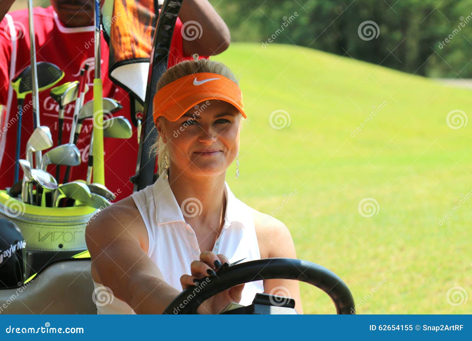 Ladies pro golfer Carly Booth behind steering wheel of golf cart. BOOTH, CARLY - NOVEMBER 15: Pro Golfer Playing at Gary Player Charity Invitational Golf Tournament behind steering wheel of golf cart on November 15, 2015, Sun City, South Africa.