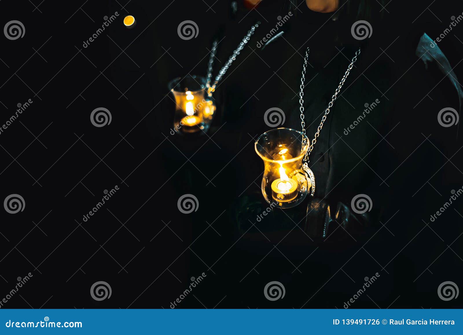 ladies of the virgin of solitude during holy week semana santa in zamora, spain with a distinctive medal and with a glass tulip