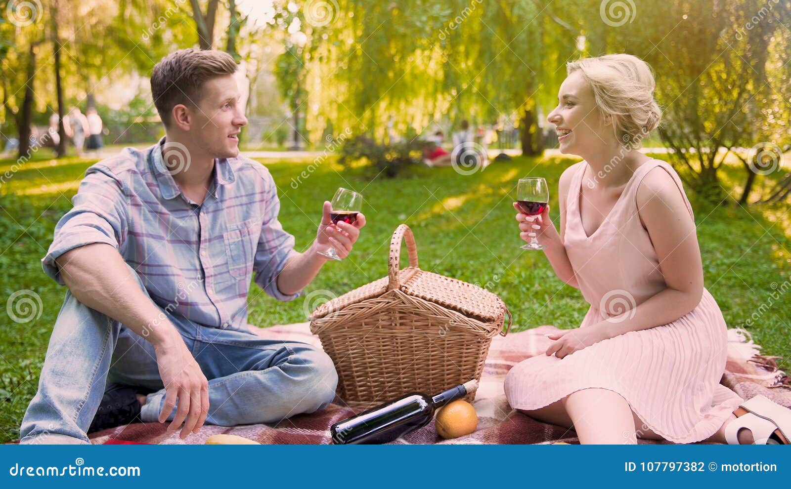 Lady Admiringly Sharing News With Boyfriend, Sipping Wine In Shade Of Park ...