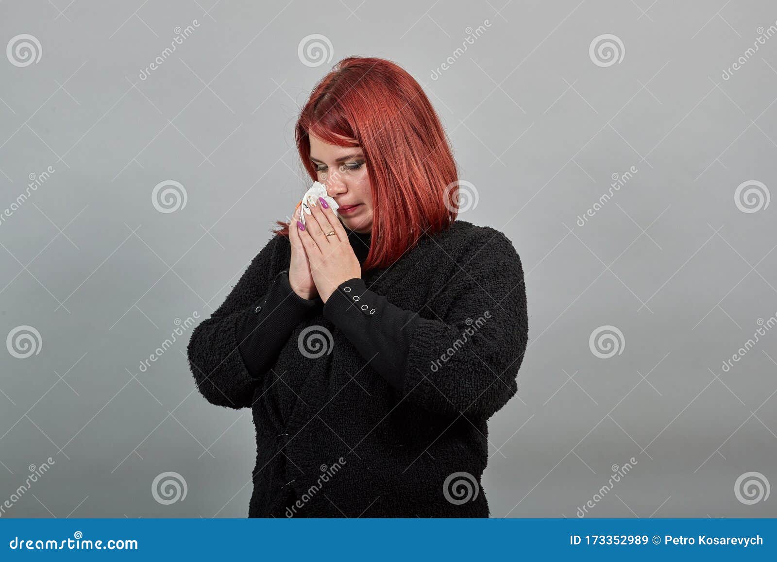 lady in black sweater sick woman with snot in a handkerchief, cold, runny nose