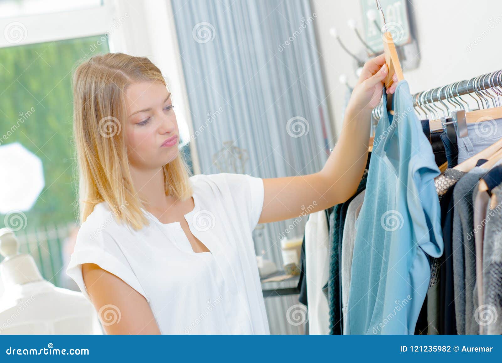 Lady in Clothes Shop Holding Top Unsure Expression Stock Photo - Image ...