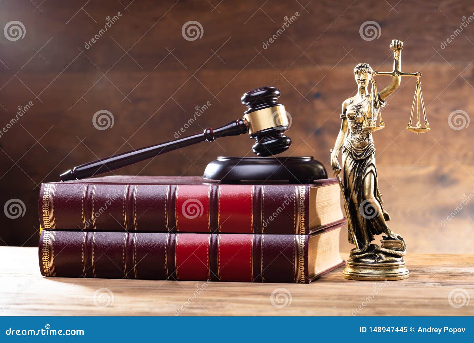 lady justice near gavel over law book