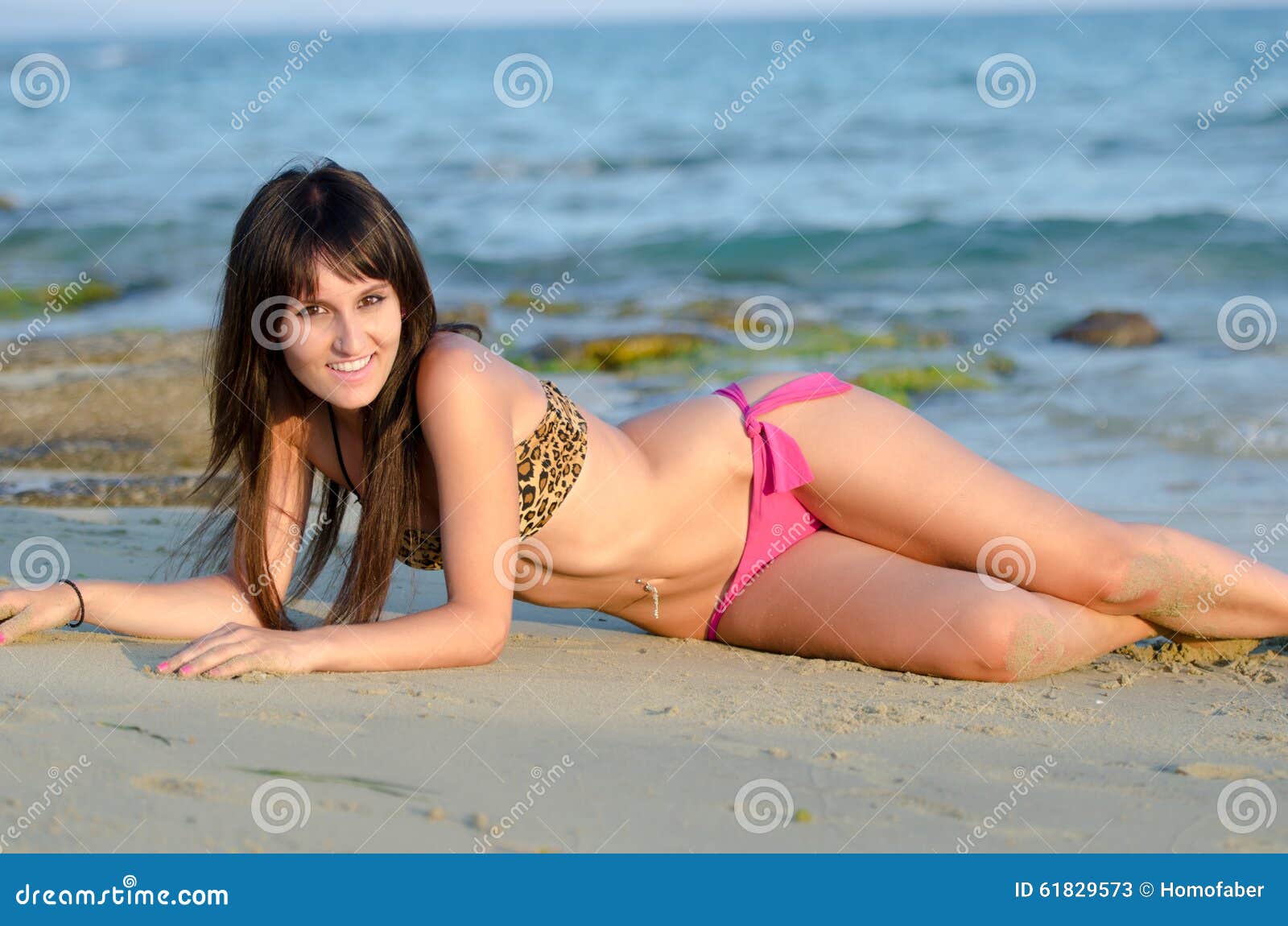 Pretty amateur girl takes off bikini on a beach