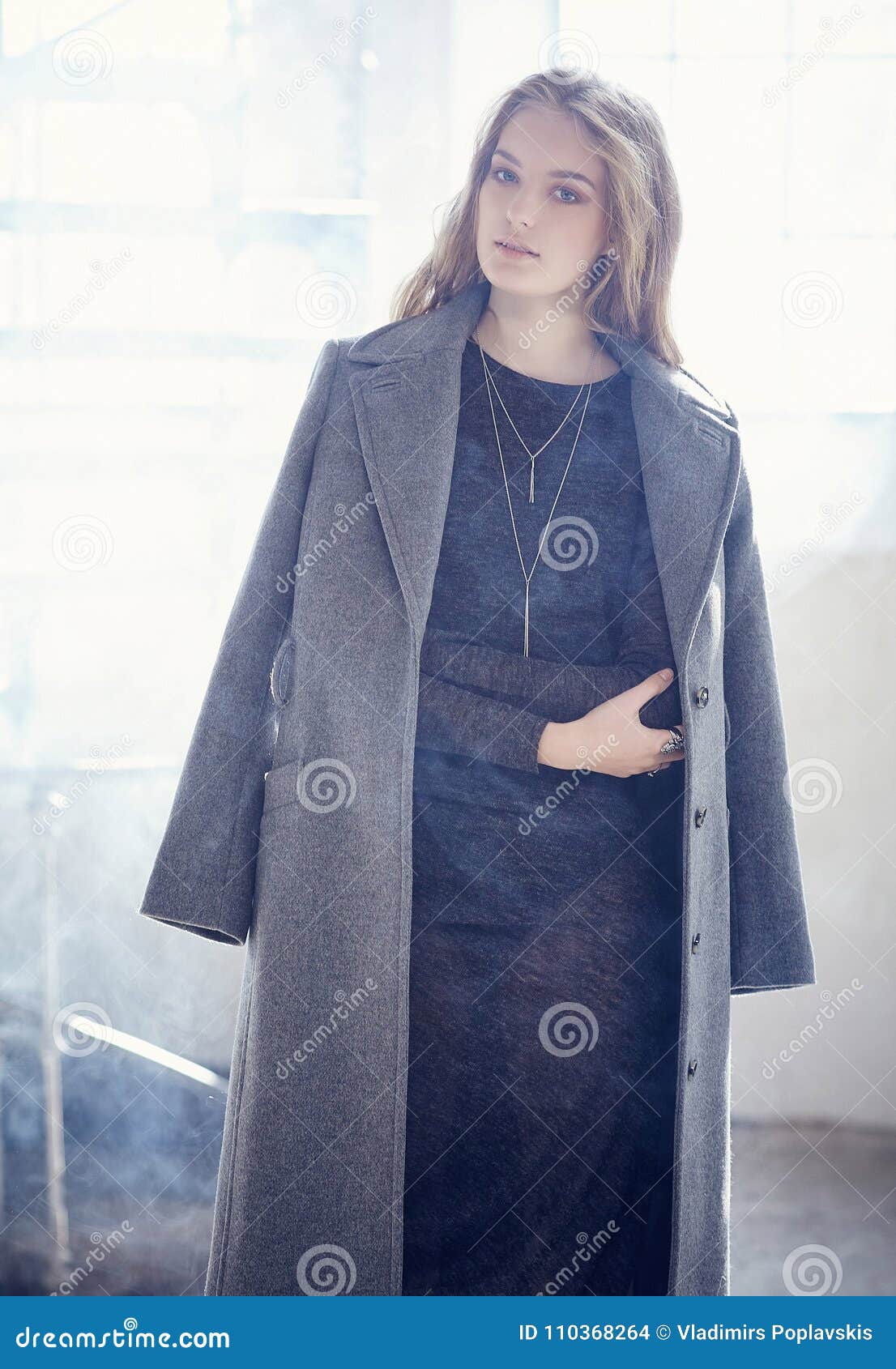 A Lady in a Long Grey Jacket. Stock Photo Image of females, cheerful