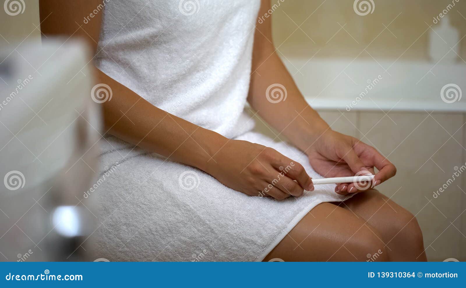lady looking at negative pregnancy test at bathroom, infertility disease