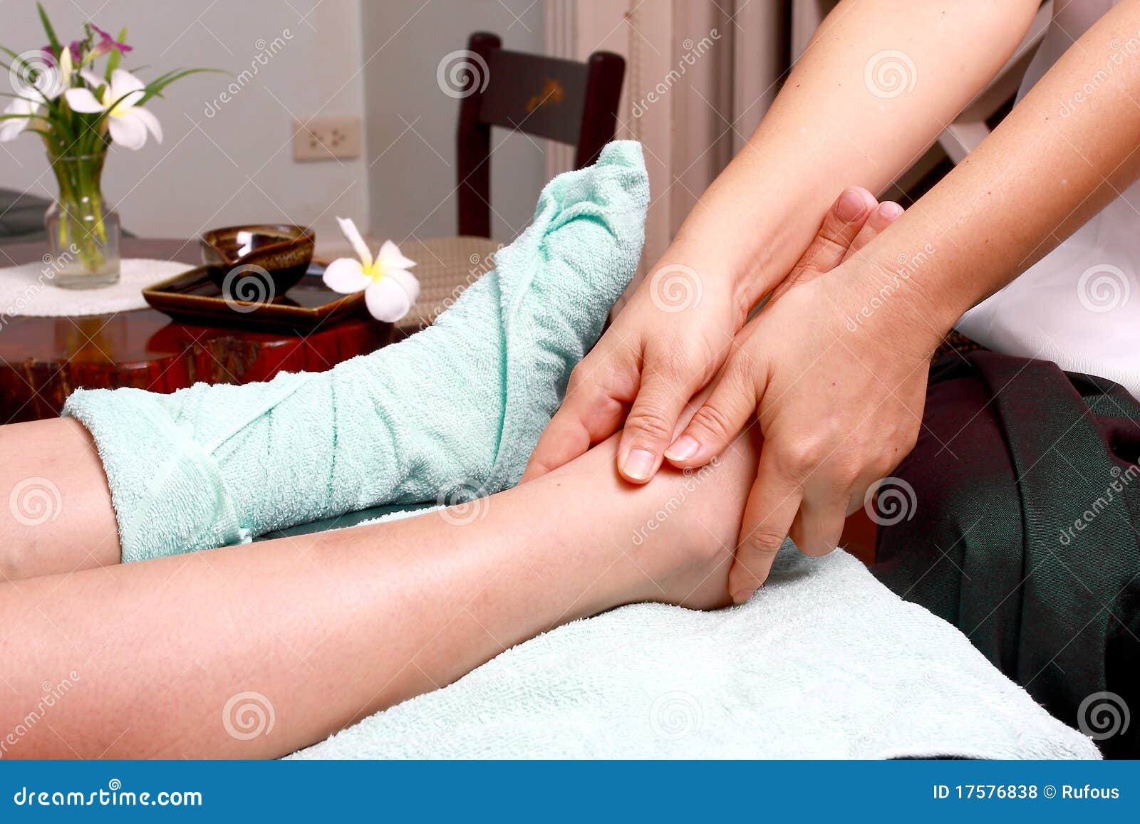 Lady Masseur Giving Patient A Leg Massage Royalty Free